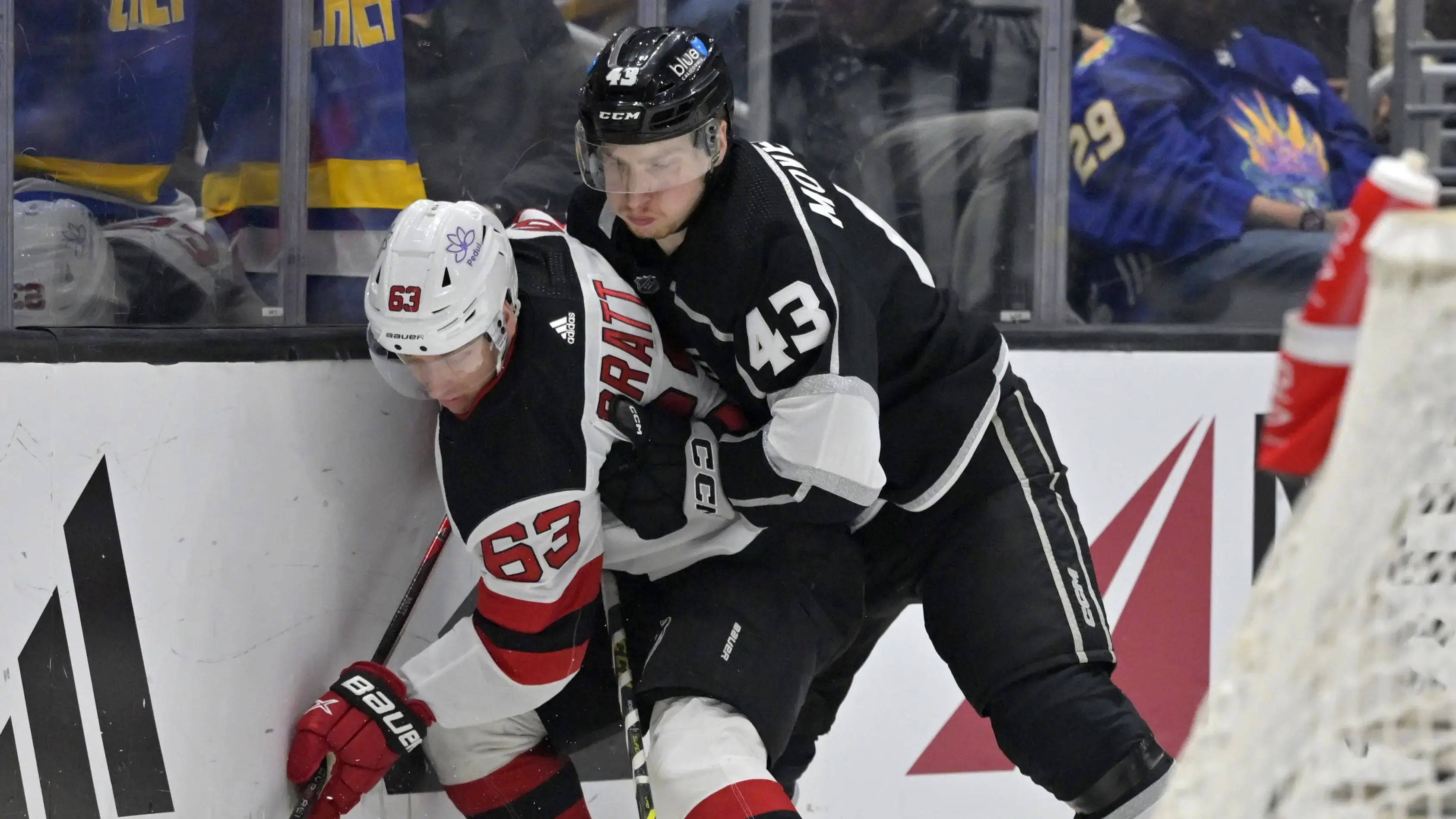 New Jersey Devils left wing Jesper Bratt (63) and Los Angeles Kings defenseman Jacob Moverare (43) battle along the boards in the first period at Crypto.com Arena / Jayne Kamin-Oncea - USA TODAY Sports
