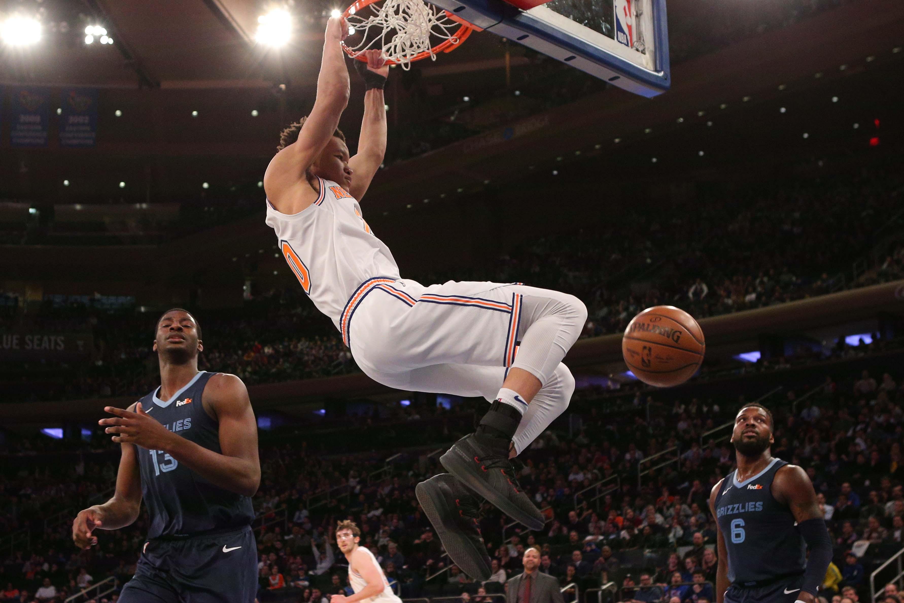 Feb 3, 2019; New York, NY, USA; New York Knicks forward Kevin Knox (20) dunks over Memphis Grizzlies forward Jaren Jackson Jr. (13) and guard Shelvin Mack (6) during the third quarter at Madison Square Garden. Mandatory Credit: Brad Penner-USA TODAY Sports / Brad Penner