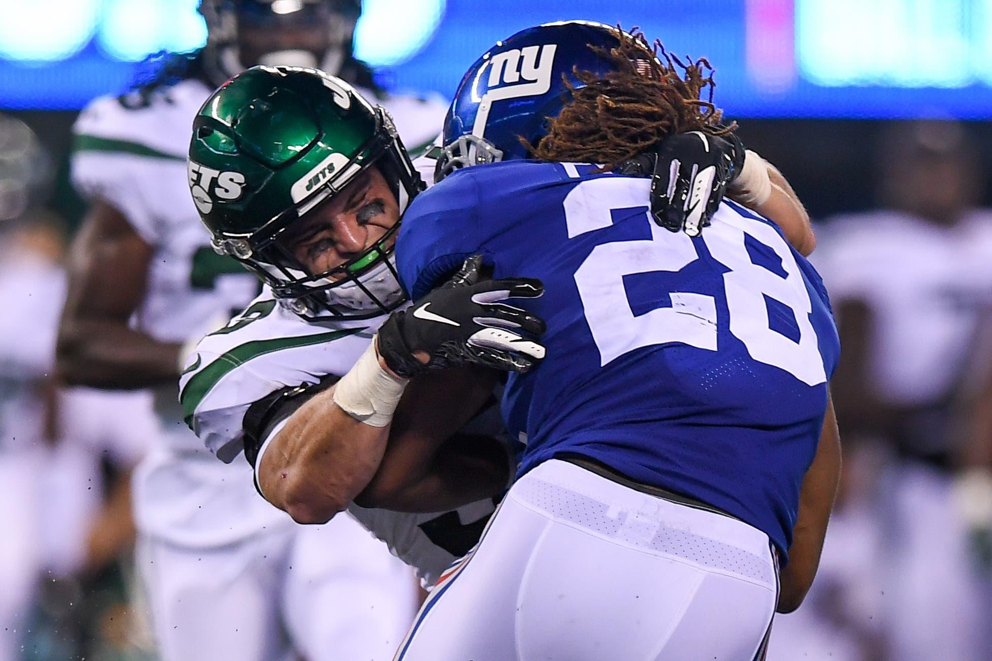 Aug 8, 2019; East Rutherford, NJ, USA; New York Jets linebacker Blake Cashman (53) tackles New York Giants running back Paul Perkins (28) during the second half at MetLife Stadium. Mandatory Credit: Dennis Schneidler-USA TODAY Sports / Dennis Schneidler