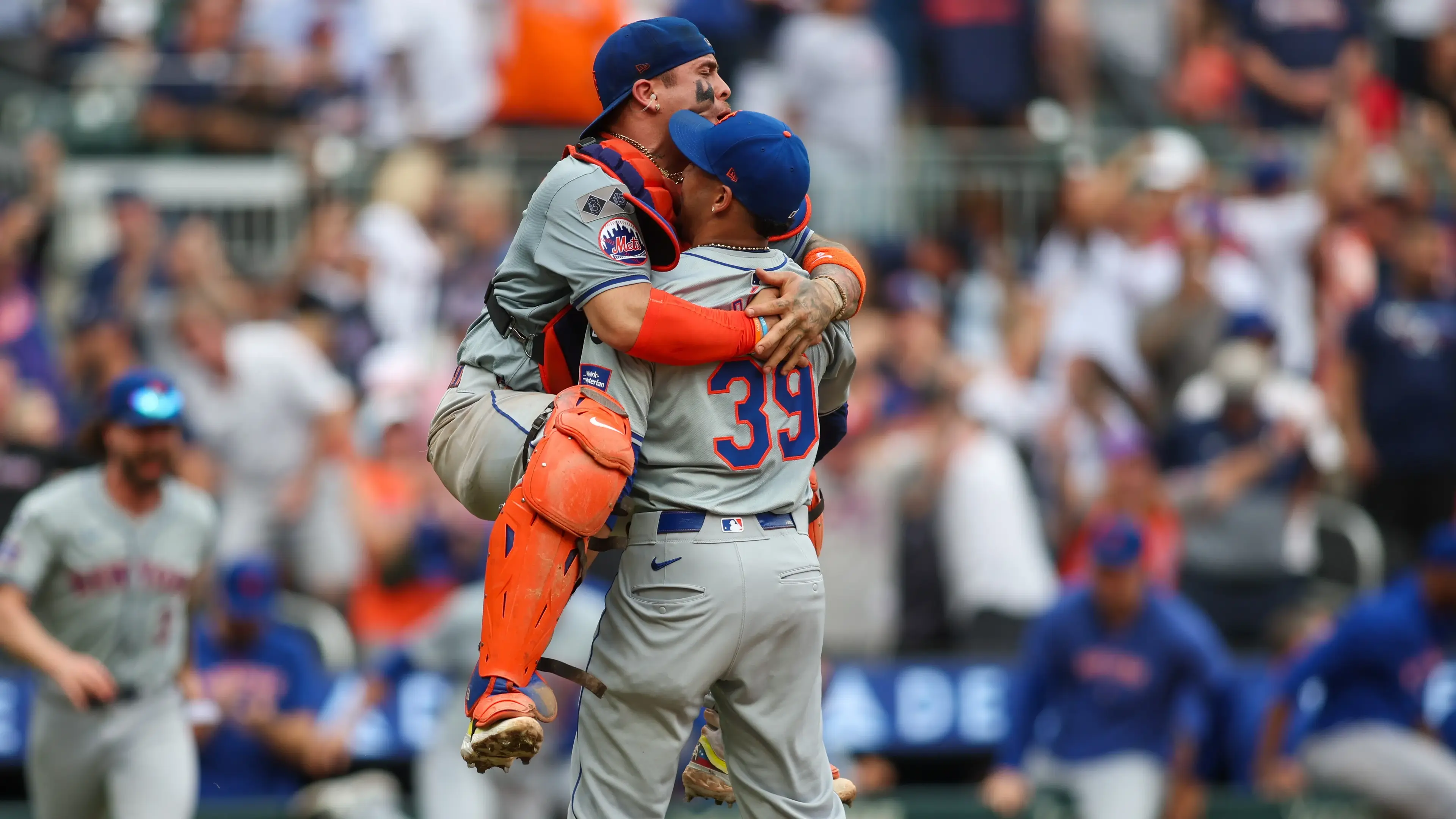 New York Mets catcher Francisco Alvarez (4) jumps onto relief pitcher Edwin Diaz (39) after a victory over the Atlanta Braves and clinching a wild card playoff birth at Truist Park / Brett Davis - Imagn Images