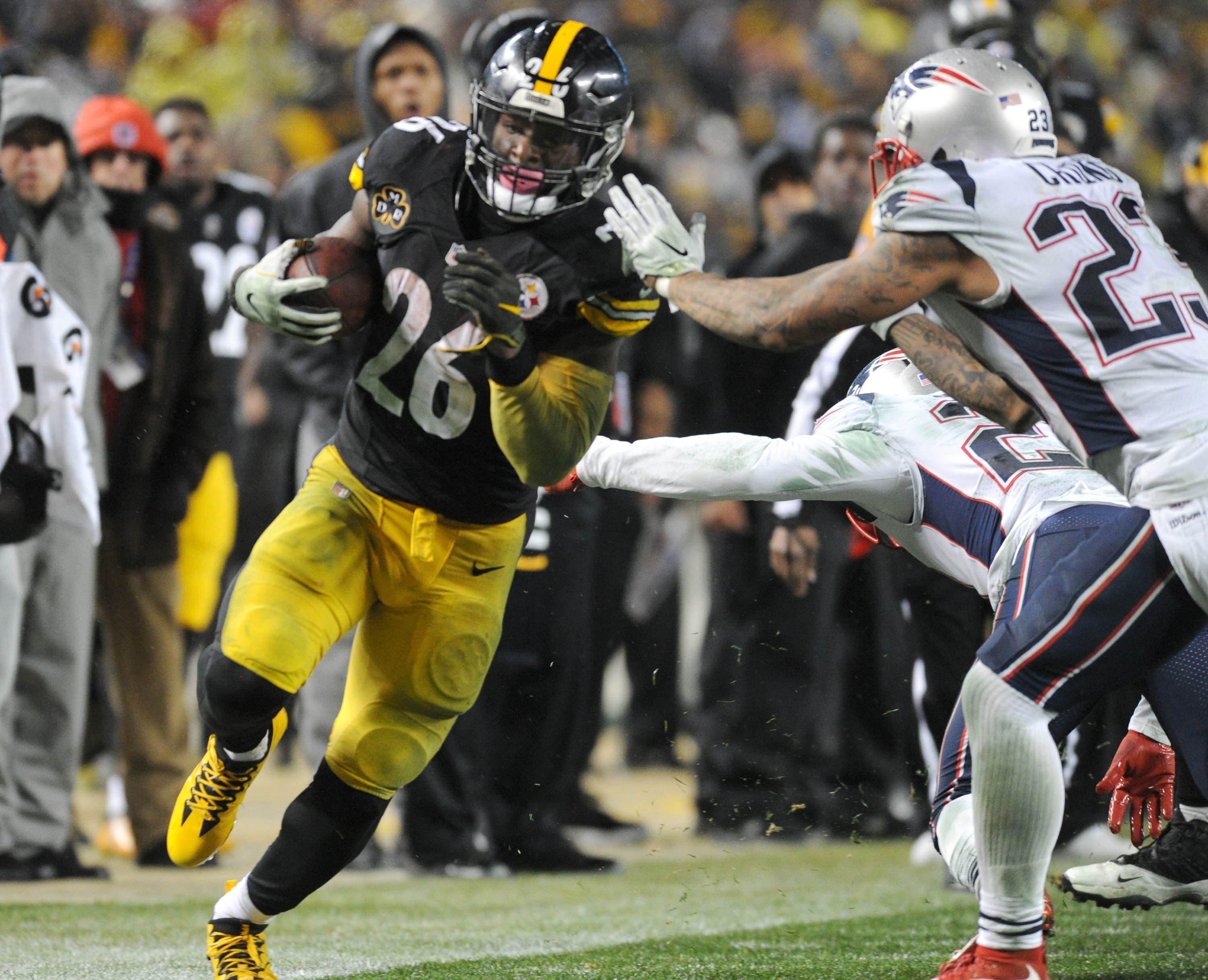 Pittsburgh Steelers running back Le'Veon Bell is pushed out of bounds by New England Patriots safety Patrick Chung in the third quarter at Heinz Field. / Philip G. Pavely/USA TODAY Sports