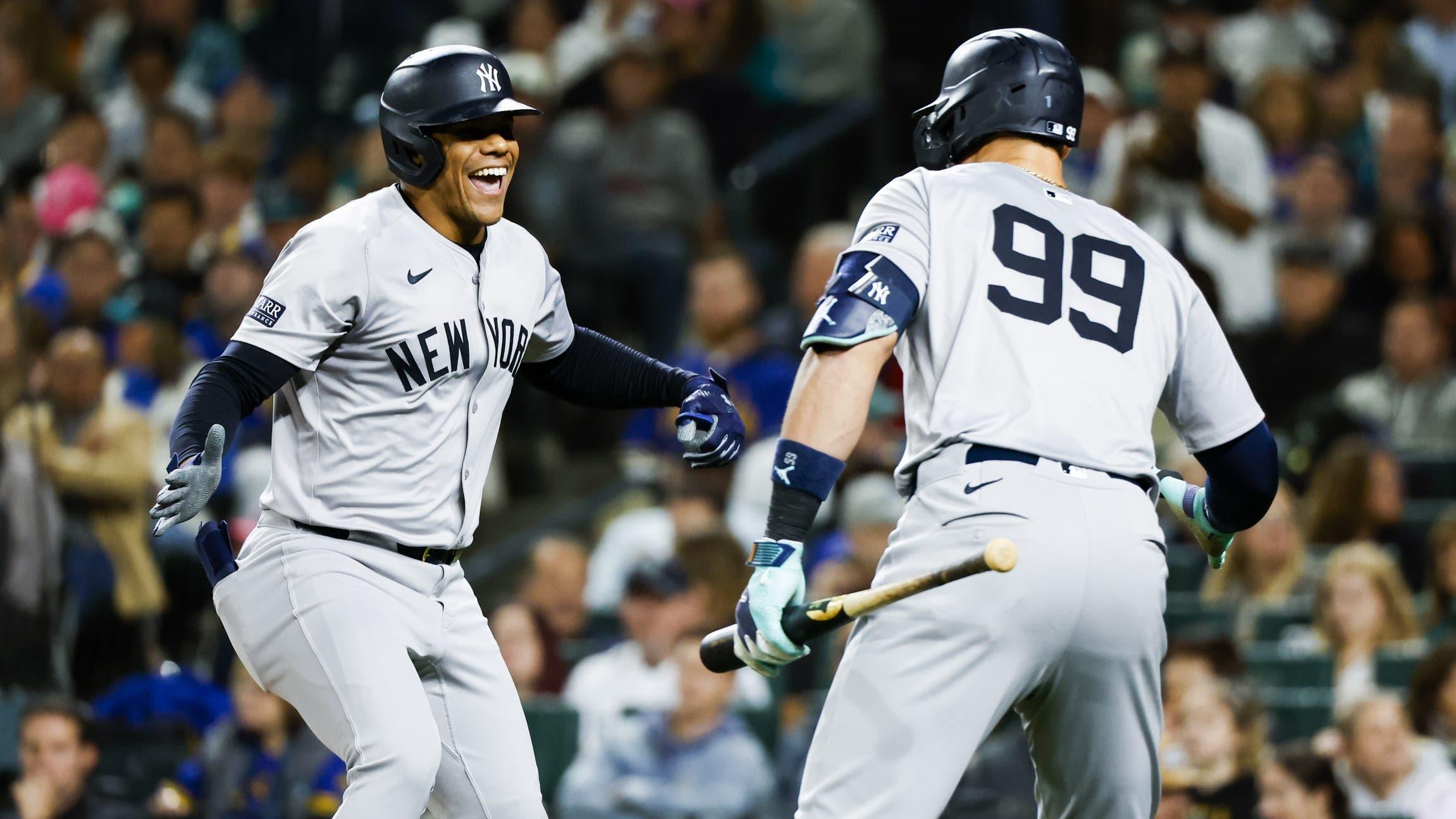 Sep 17, 2024; Seattle, Washington, USA; New York Yankees right fielder Juan Soto (22) celebrates a two-run home run against the Seattle Mariners with designated hitter Aaron Judge (99) during the fourth inning at T-Mobile Park. / Joe Nicholson-Imagn Images