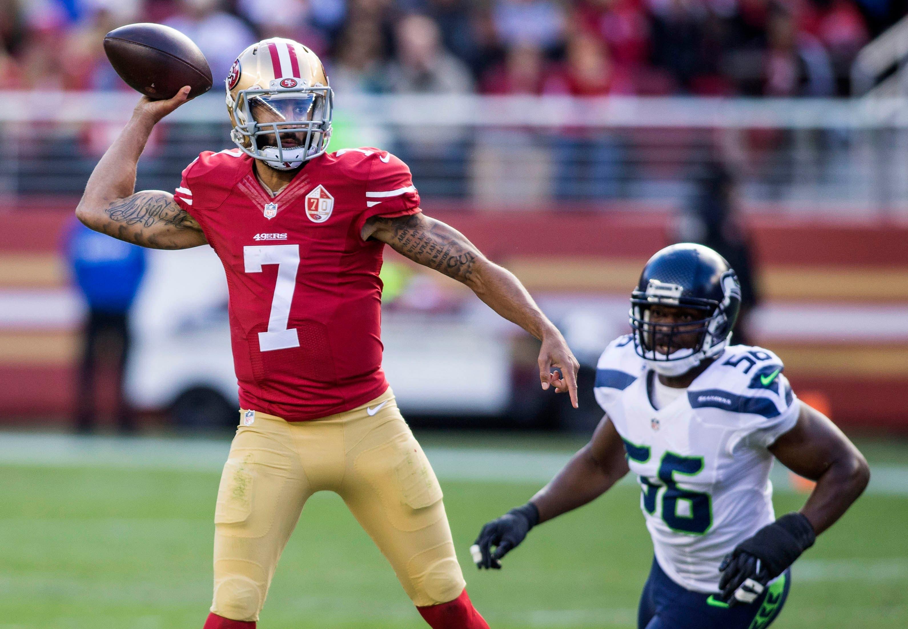 Jan 1, 2017; Santa Clara, CA, USA; San Francisco 49ers quarterback Colin Kaepernick (7) passes the football while being rushed by Seattle Seahawks defensive end Cliff Avril (56) during the first quarter at Levis Stadium. Mandatory Credit: Neville E. Guard-USA TODAY Sports / Neville E. Guard