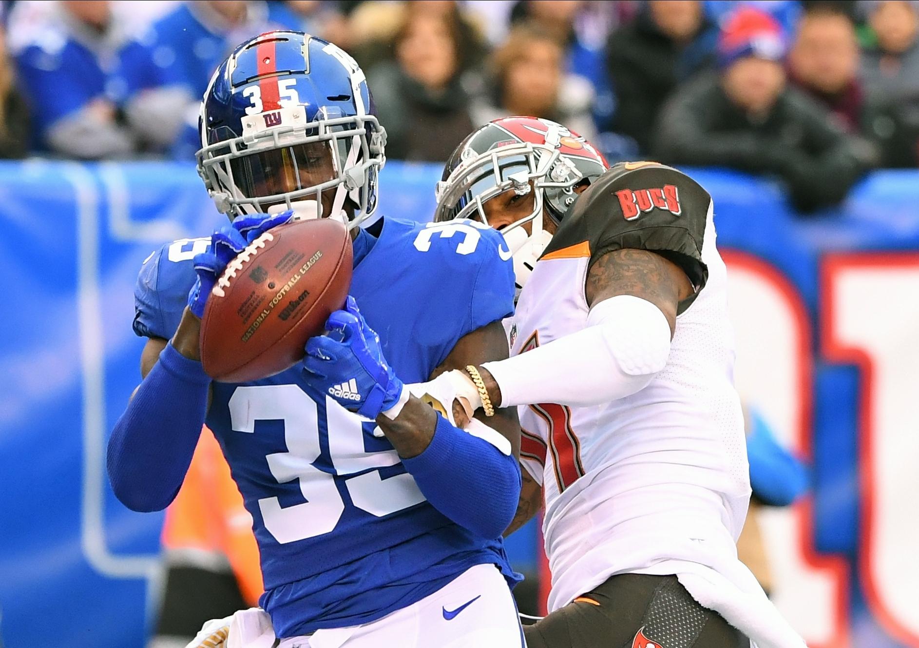 New York Giants cornerback Curtis Riley intercepts a pass intended for Tampa Bay Buccaneers wide receiver DeSean Jackson in the fourth quarter at MetLife Stadium.