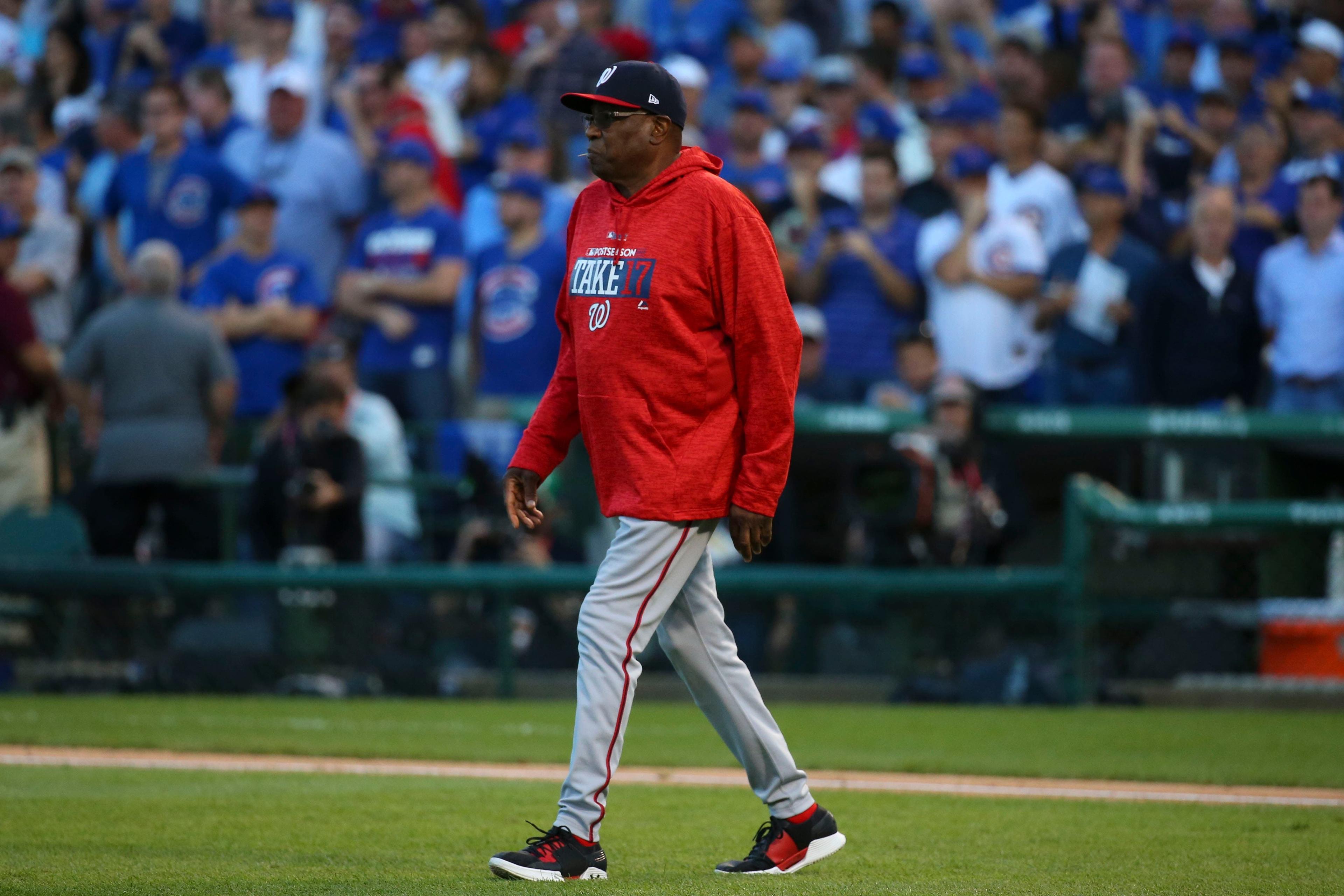 Oct 9, 2017; Chicago, IL, USA; Washington Nationals manager Dusty Baker (12) walks to the mound against the Chicago Cubs during the seventh inning in game three of the 2017 NLDS playoff baseball series at Wrigley Field. Mandatory Credit: Jerry Lai-USA TODAY Sports / Jerry Lai