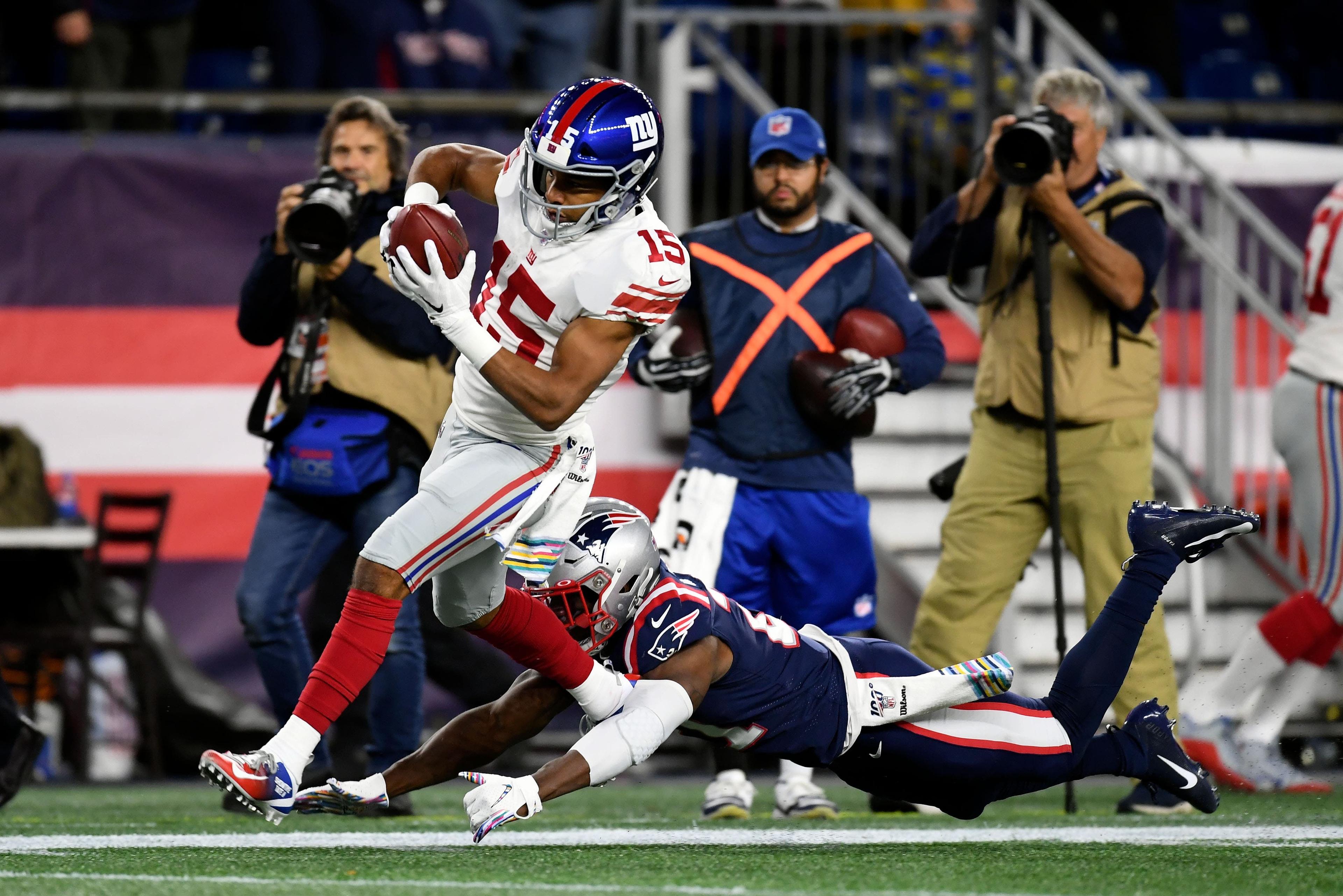 Oct 10, 2019; Foxborough, MA, USA; New York Giants wide receiver Golden Tate (15) breaks a tackle to run from New England Patriots strong safety Duron Harmon (21) during the first half at Gillette Stadium. Mandatory Credit: Bob DeChiara-USA TODAY Sports / Bob DeChiara