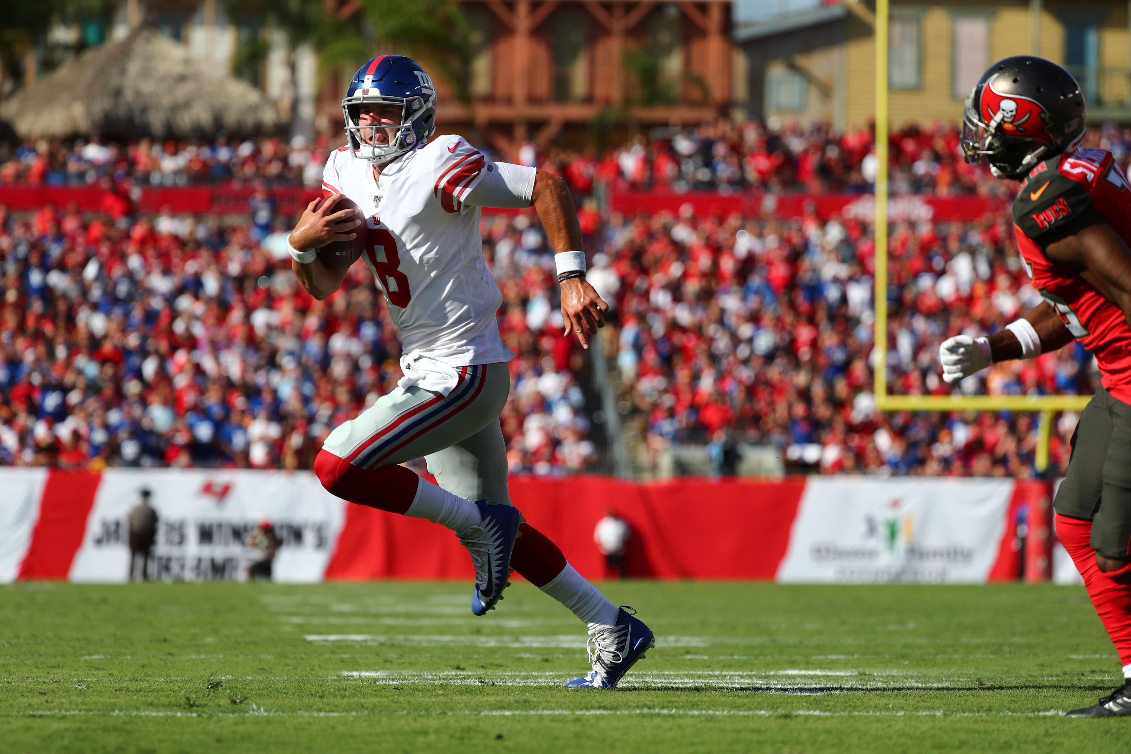 Sep 22, 2019; Tampa, FL, USA;New York Giants quarterback Daniel Jones (8) runs the ball in for a touchdown against Tampa Bay Buccaneers cornerback M.J. Stewart (36) during the second quarter at Raymond James Stadium. Mandatory Credit: Kim Klement-USA TODAY Sports / Kim Klement