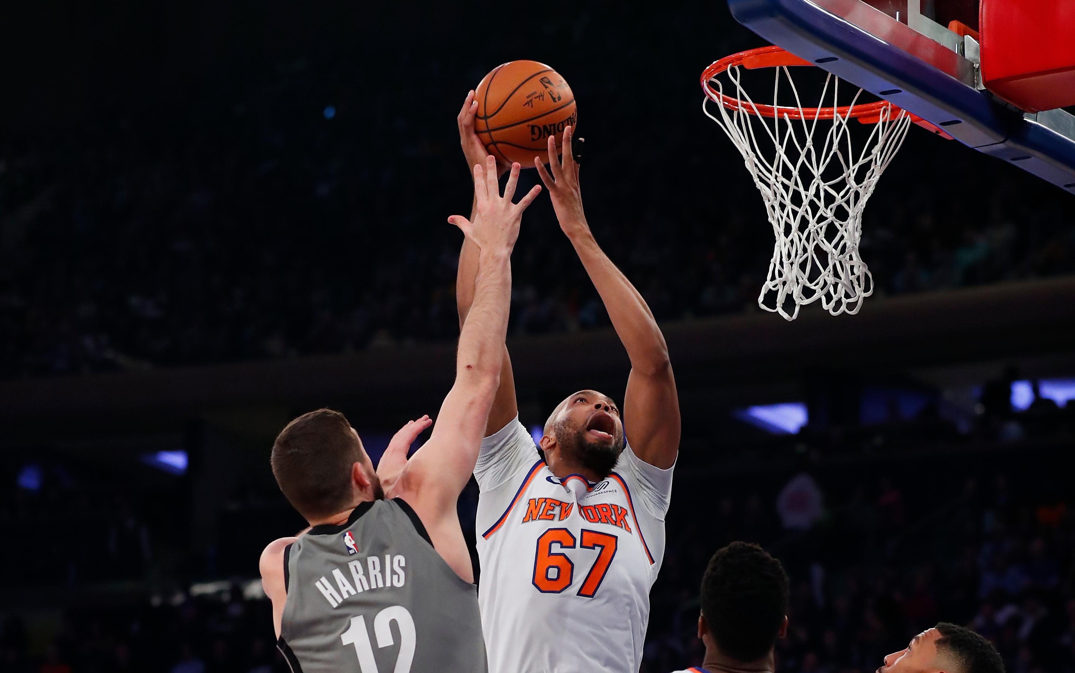 Nov 24, 2019; New York, NY, USA; New York Knicks forward Taj Gibson (67) goes to the basket against Brooklyn Nets guard Joe Harris (12) during the first half at Madison Square Garden. Mandatory Credit: Noah K. Murray-USA TODAY Sports