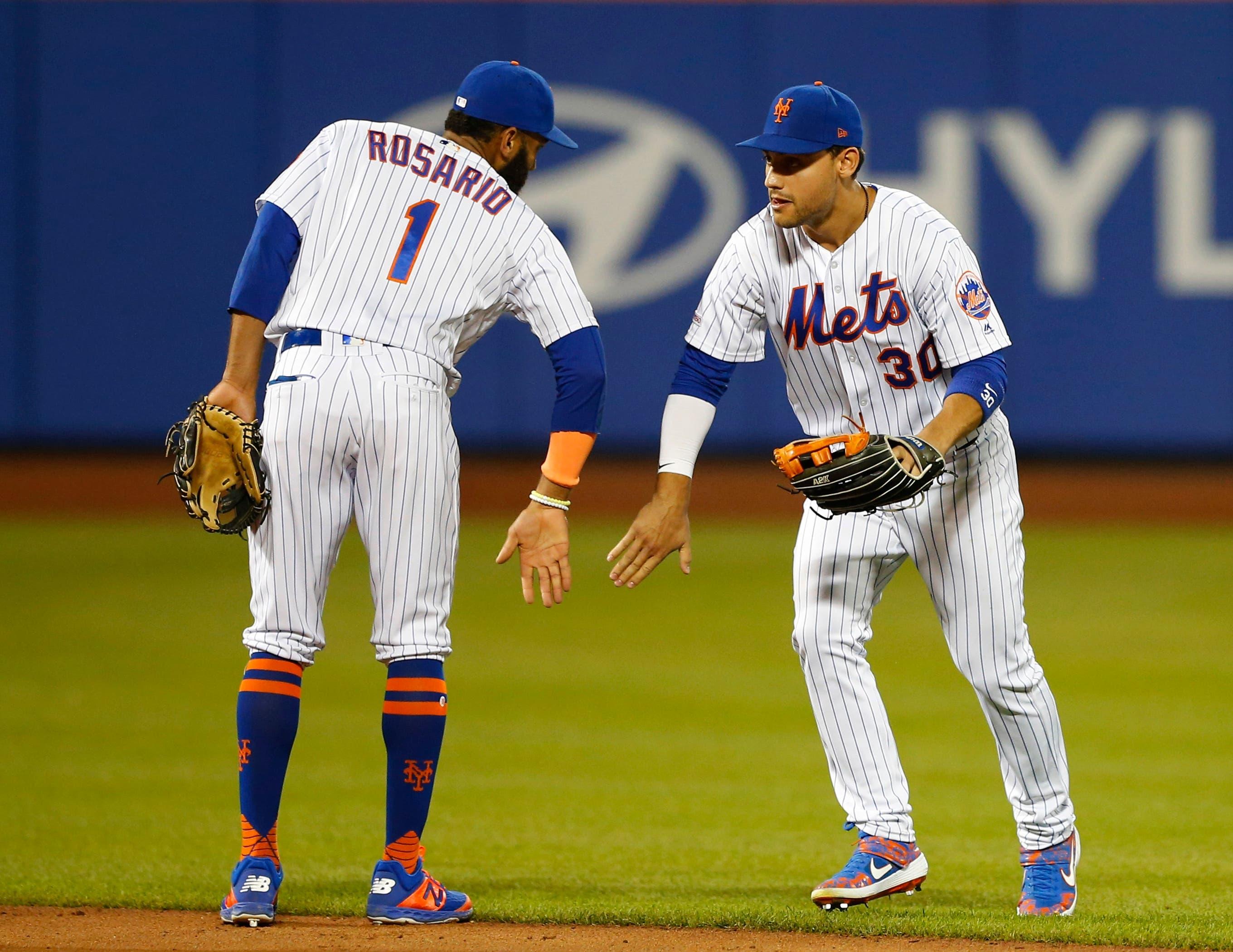 Jun 5, 2019; New York City, NY, USA; New York Mets shortstop Amed Rosario (1) and New York Mets right fielder Michael Conforto (30) celebrate after defeating the San Francisco Giants at Citi Field. Mandatory Credit: Noah K. Murray-USA TODAY Sports / Noah K. Murray