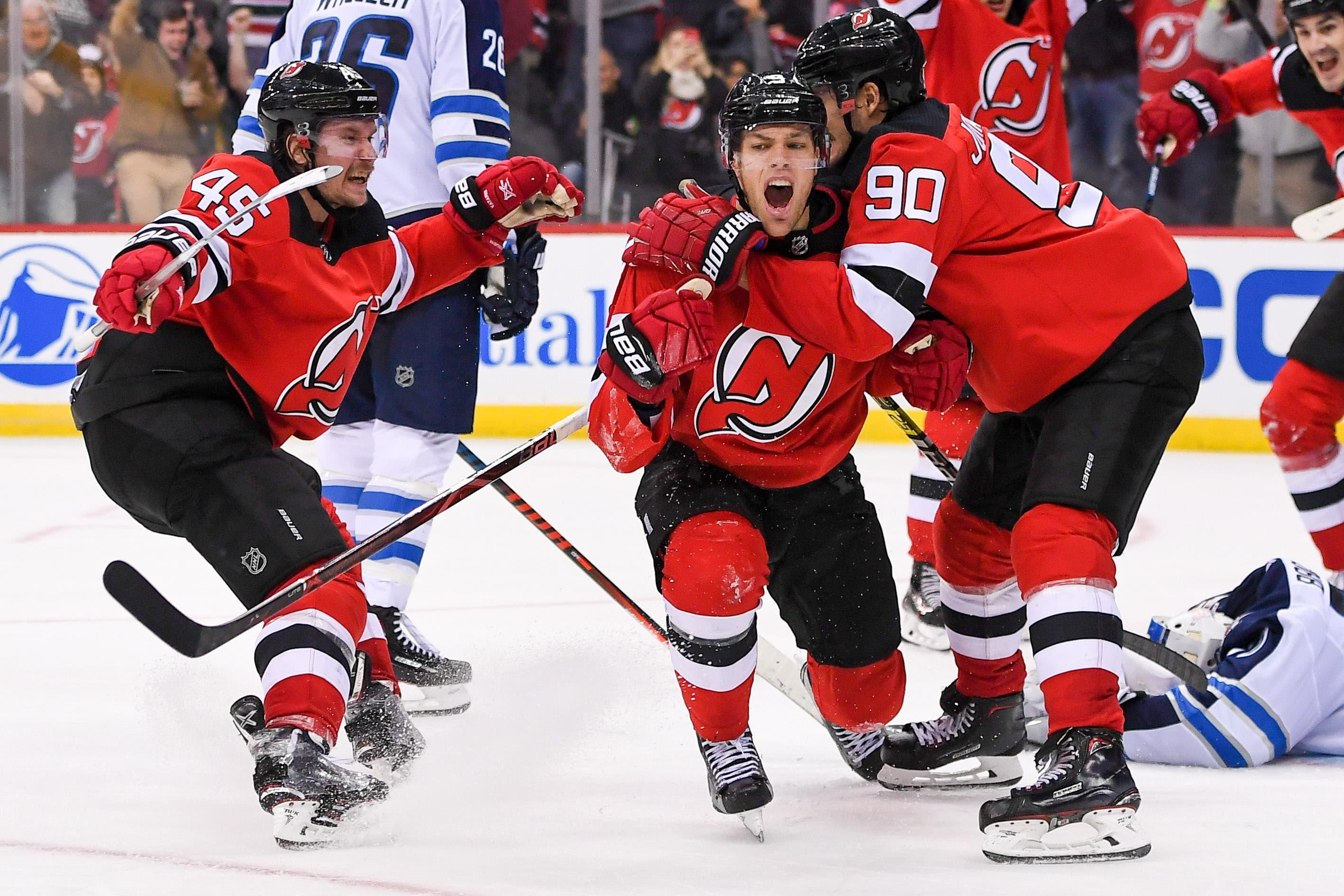 Dec 1, 2018; Newark, NJ, USA; New Jersey Devils left wing Taylor Hall (9) celebrates his goal with left wing Marcus Johansson (90) and defenseman Sami Vatanen (45) against the Winnipeg Jets during the third period at Prudential Center. Mandatory Credit: Dennis Schneidler-USA TODAY Sports / Dennis Schneidler