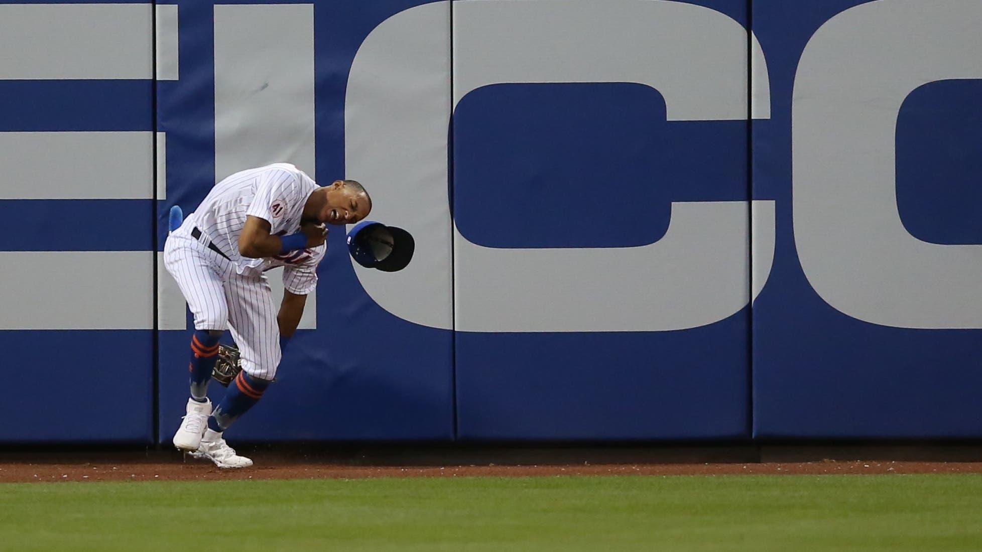 May 24, 2021; New York City, New York, USA; New York Mets center fielder Johneshwy Fargas (81) reacts after crashing into the wall while trying to catch an RBI triple by Colorado Rockies center fielder Garrett Hampson (not pictured) during the fourth inning at Citi Field / © Brad Penner-USA TODAY Sports