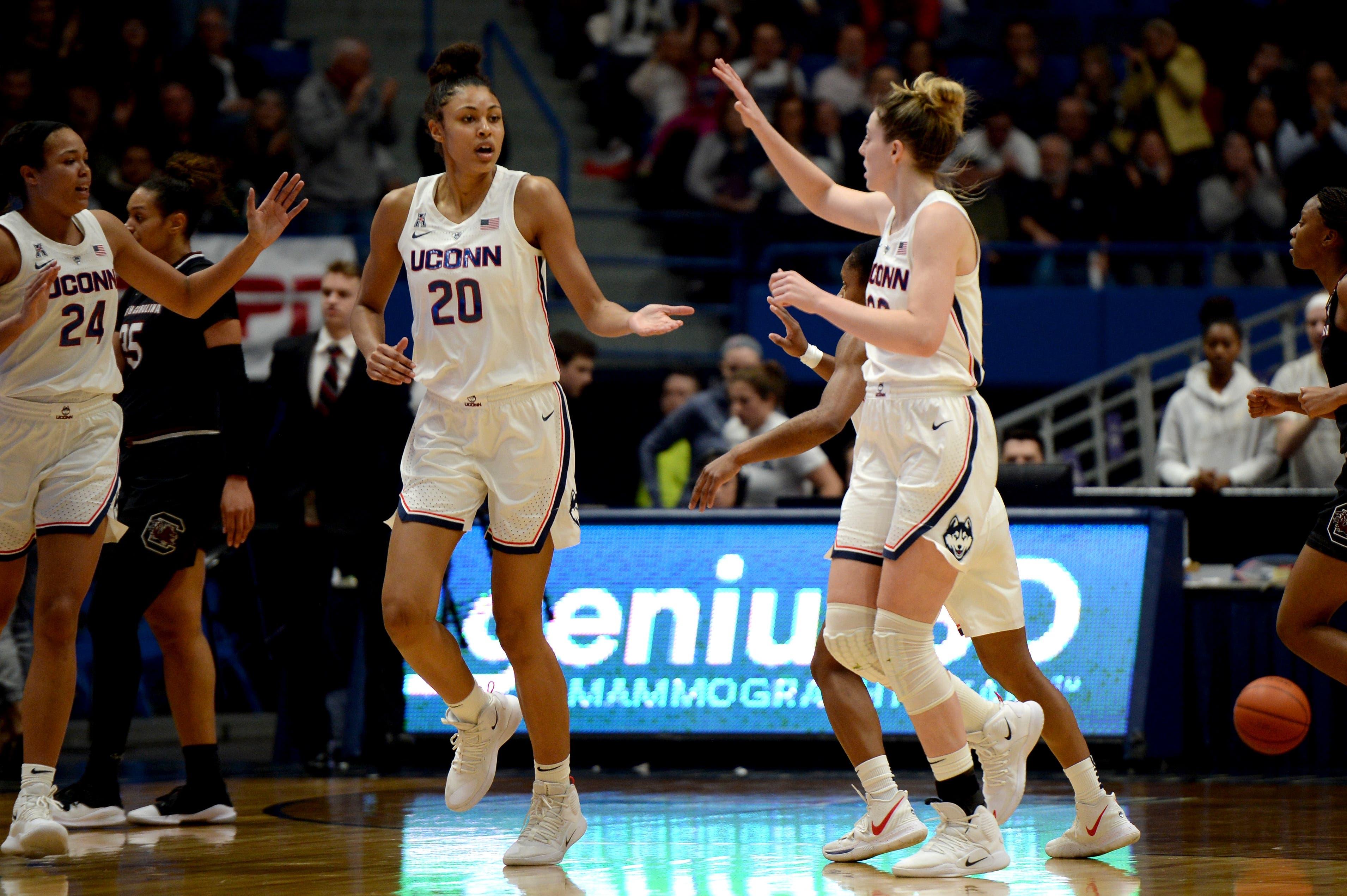 UConn freshman Olivia Nelson-Odoba congratulates teammates during a timeout in a game against South Carolina at XL Center. / Matt Eisenberg