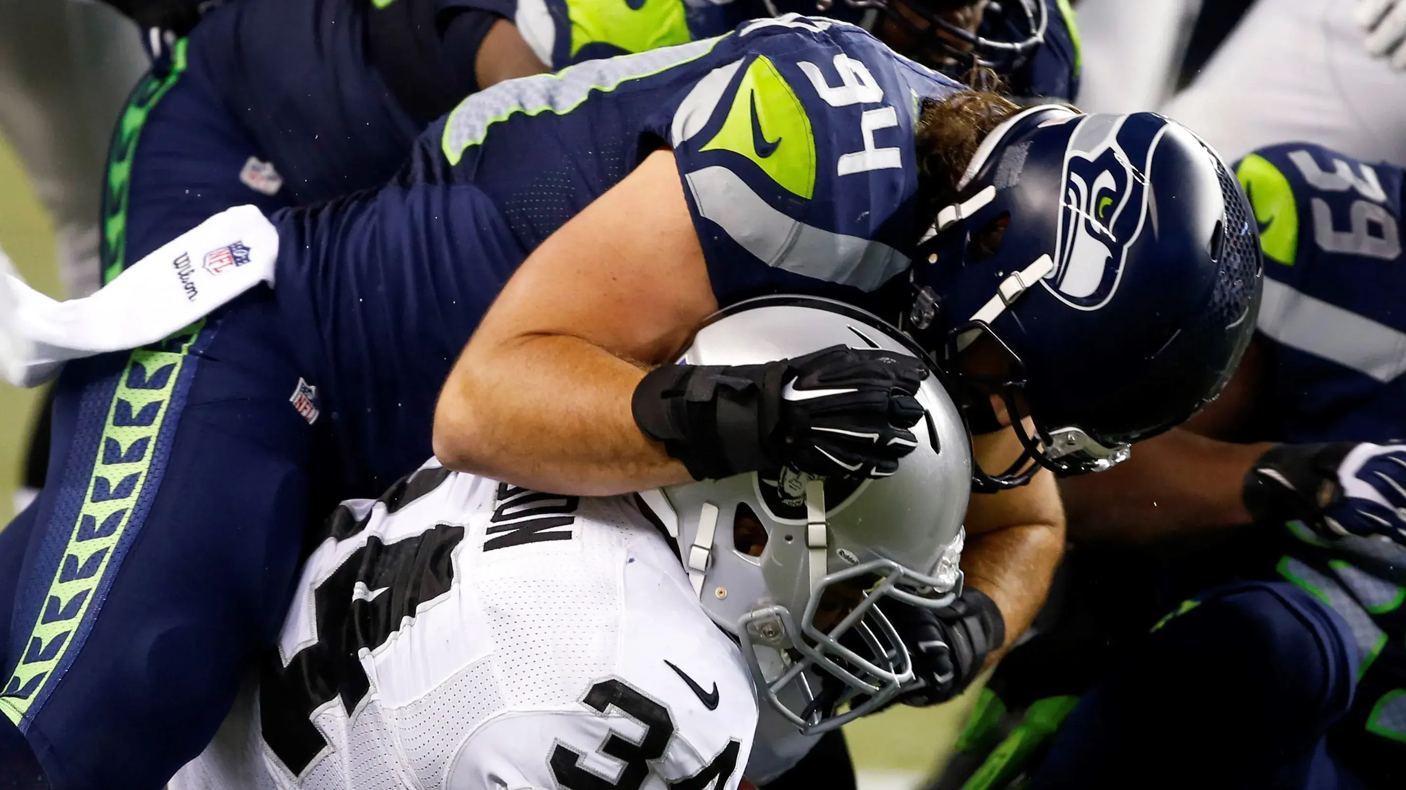 Seattle Seahawks linebacker Alex Singleton (94) tackles Oakland Raiders running back George Atkinson III (34) during the fourth quarter at CenturyLink Field. / Joe Nicholson - USA TODAY Sports