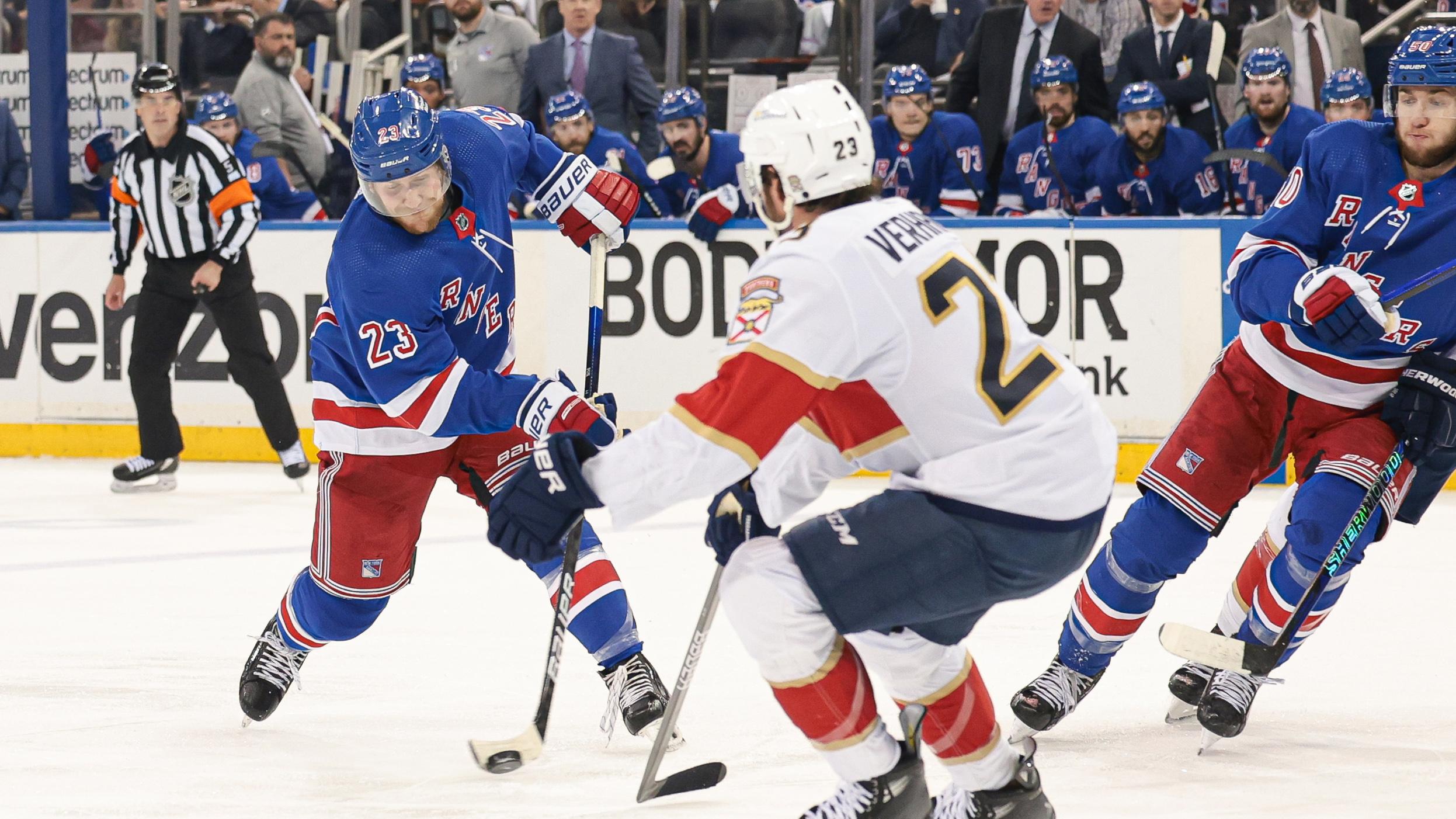 New York Rangers defenseman Adam Fox (23) shoots the puck as Florida Panthers center Carter Verhaeghe (23) defends during the second period in game two of the Eastern Conference Final of the 2024 Stanley Cup Playoffs at Madison Square Garden. / Vincent Carchietta-USA TODAY Sports
