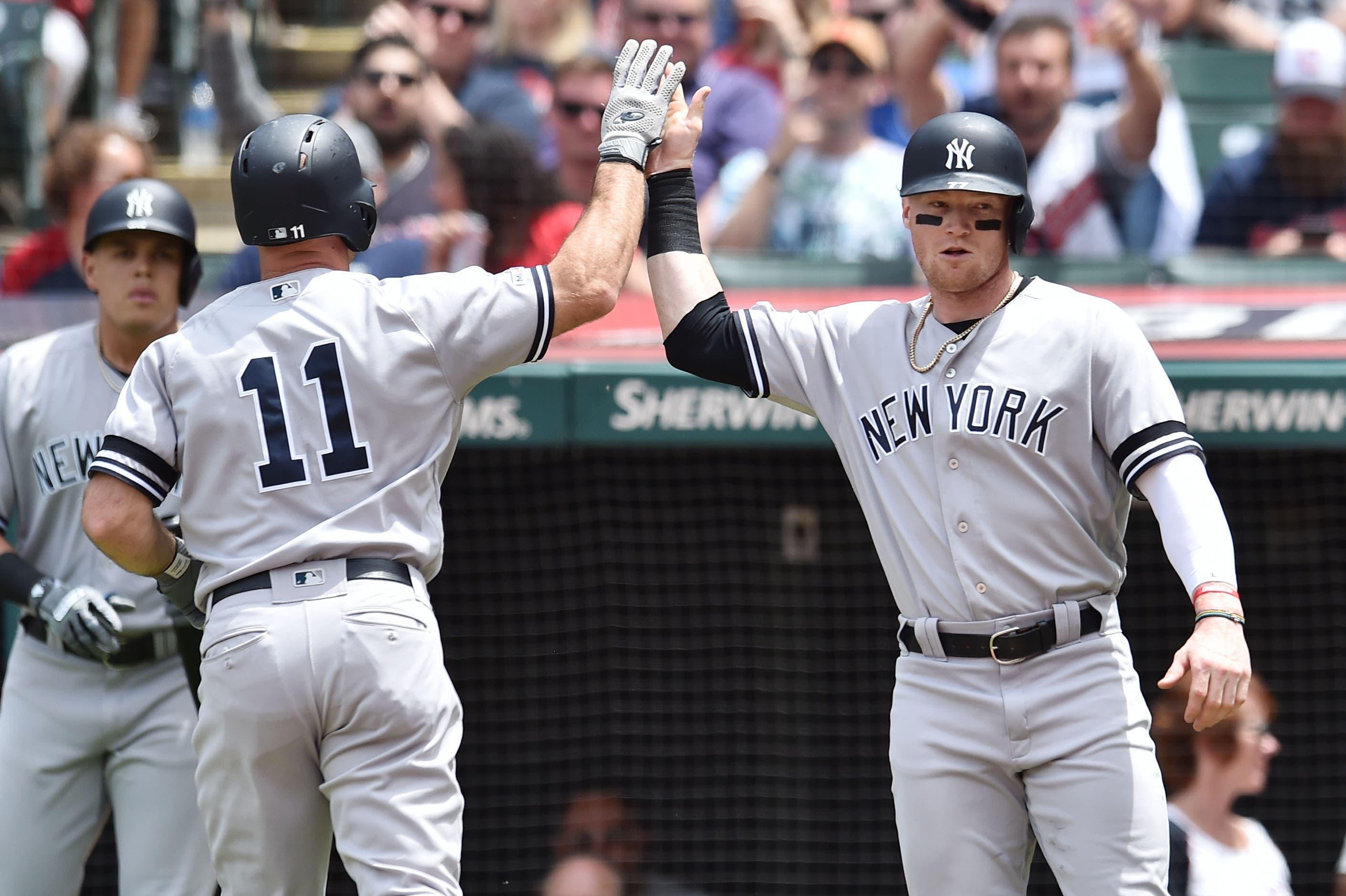 Jun 9, 2019; Cleveland, OH, USA; New York Yankees left fielder Brett Gardner (11) and designated hitter Clint Frazier (77) celebrate after Gardner hit a home run during the second inning against the Cleveland Indians at Progressive Field. Mandatory Credit: Ken Blaze-USA TODAY Sports / Ken Blaze