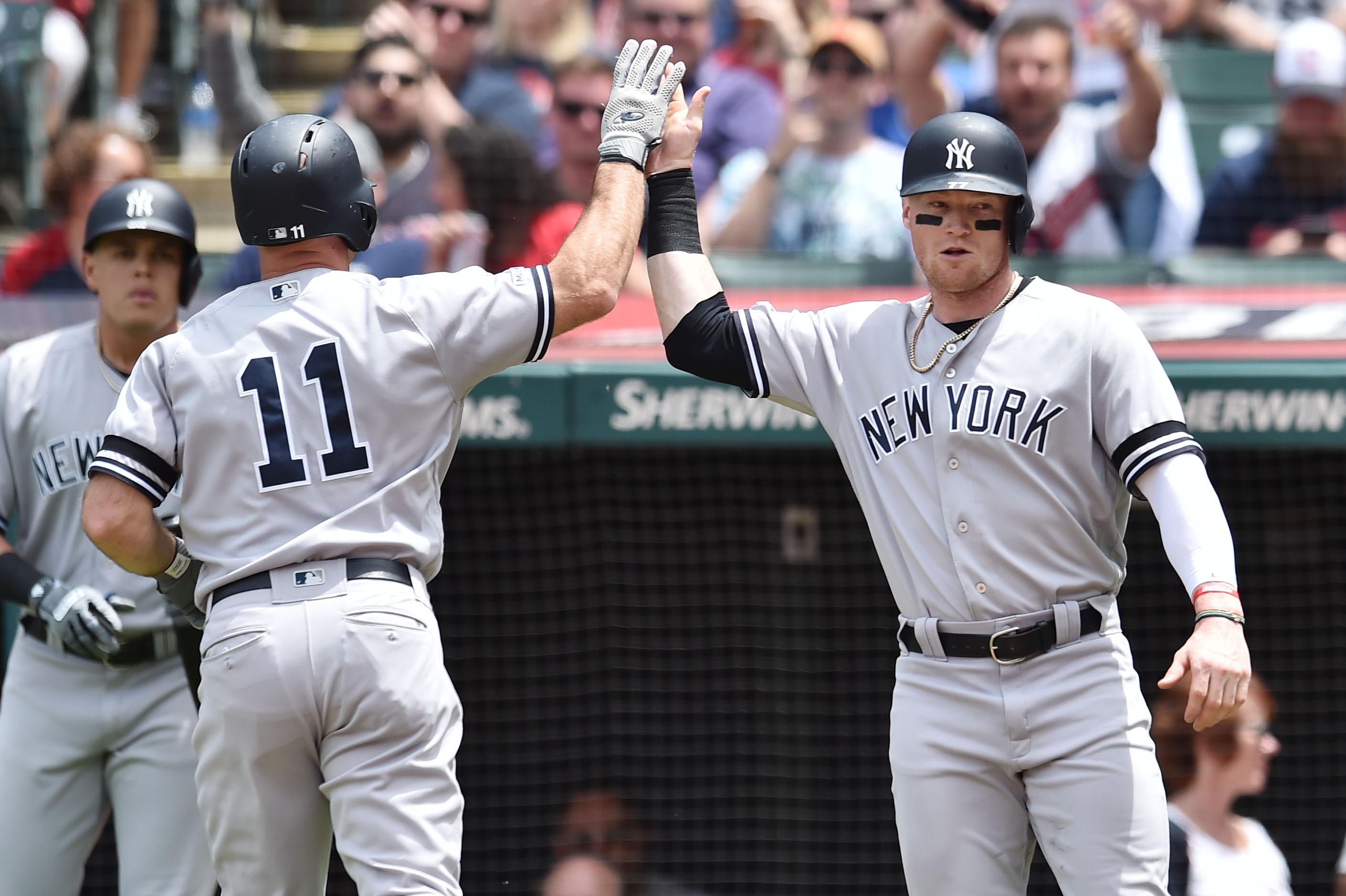 Jun 9, 2019; Cleveland, OH, USA; New York Yankees left fielder Brett Gardner (11) and designated hitter Clint Frazier (77) celebrate after Gardner hit a home run during the second inning against the Cleveland Indians at Progressive Field. Mandatory Credit: Ken Blaze-USA TODAY Sports