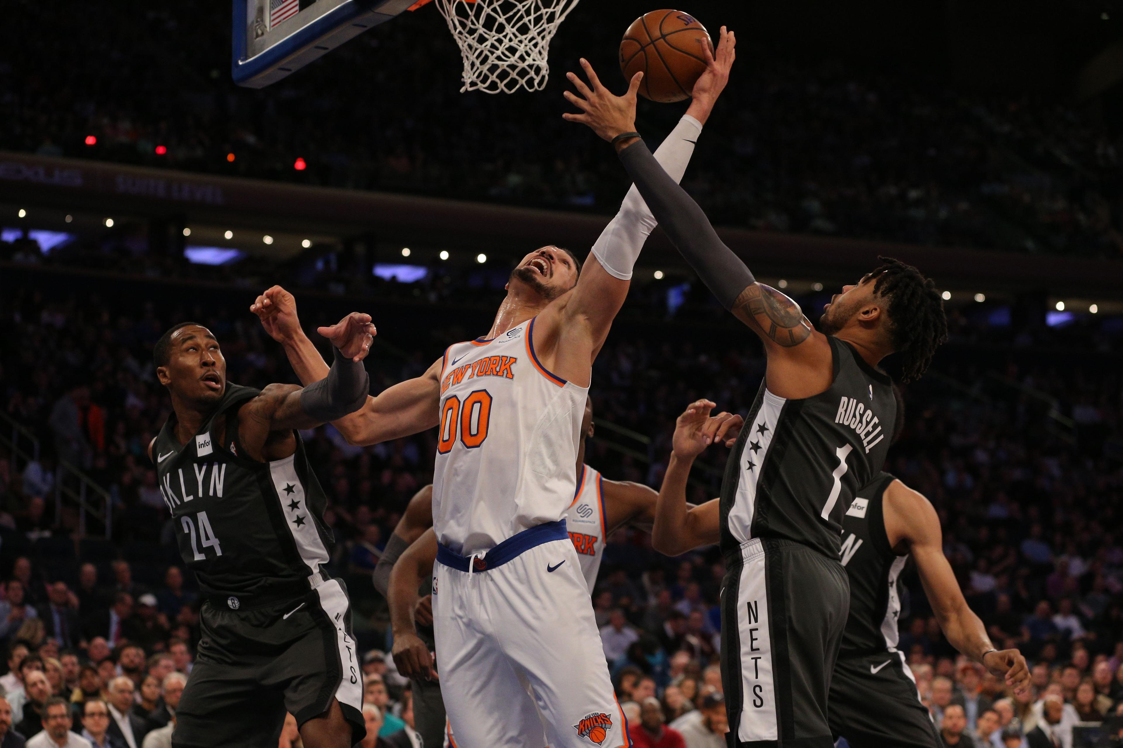 New York Knicks center Enes Kanter fights for a rebound against Brooklyn Nets forward Rondae Hollis-Jefferson and guard D'Angelo Russell during the second quarter at Madison Square Garden.