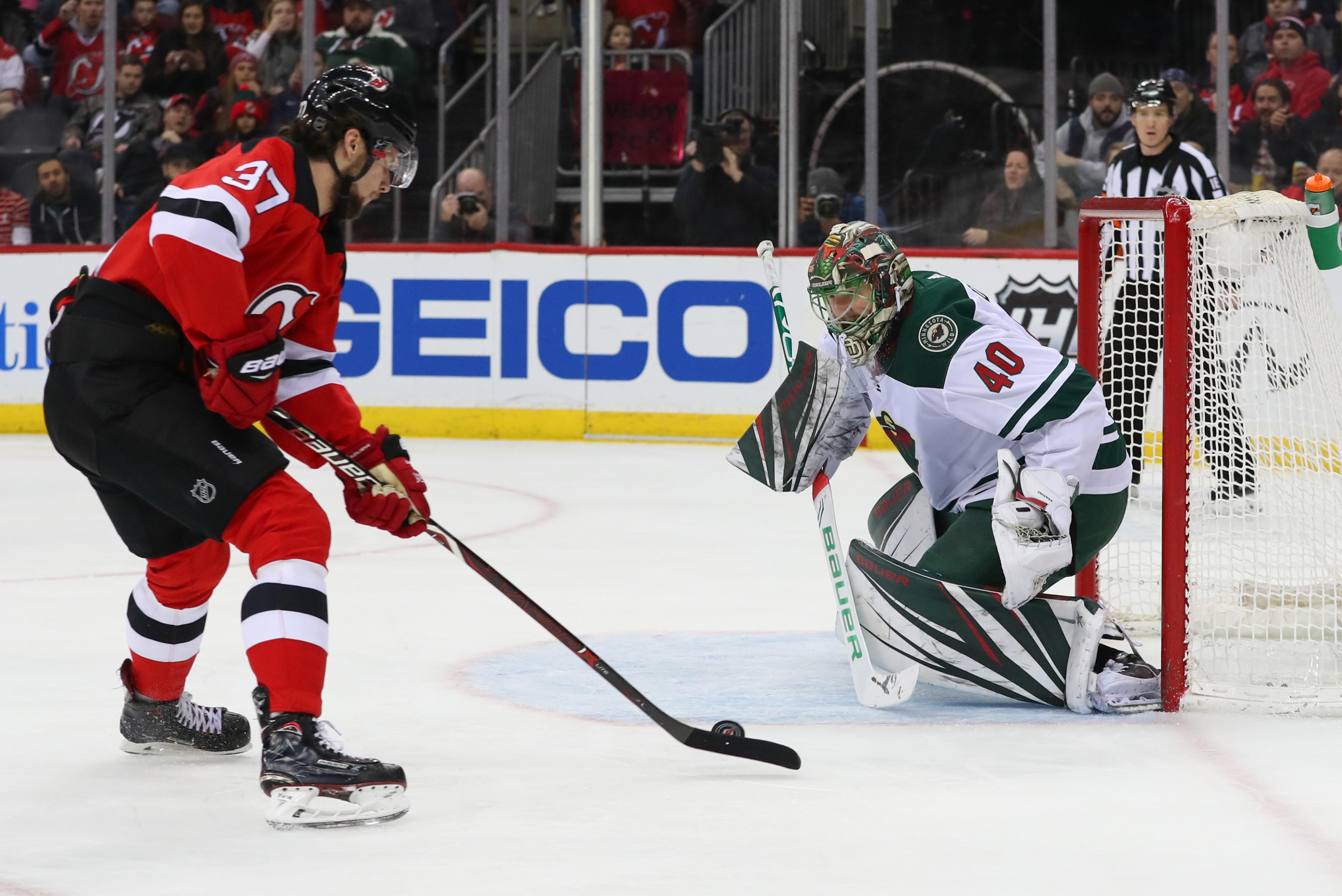 Feb 9, 2019; Newark, NJ, USA; Minnesota Wild goaltender Devan Dubnyk (40) makes a save against New Jersey Devils center Pavel Zacha (37) during the second period at Prudential Center. Mandatory Credit: Ed Mulholland-USA TODAY Sports