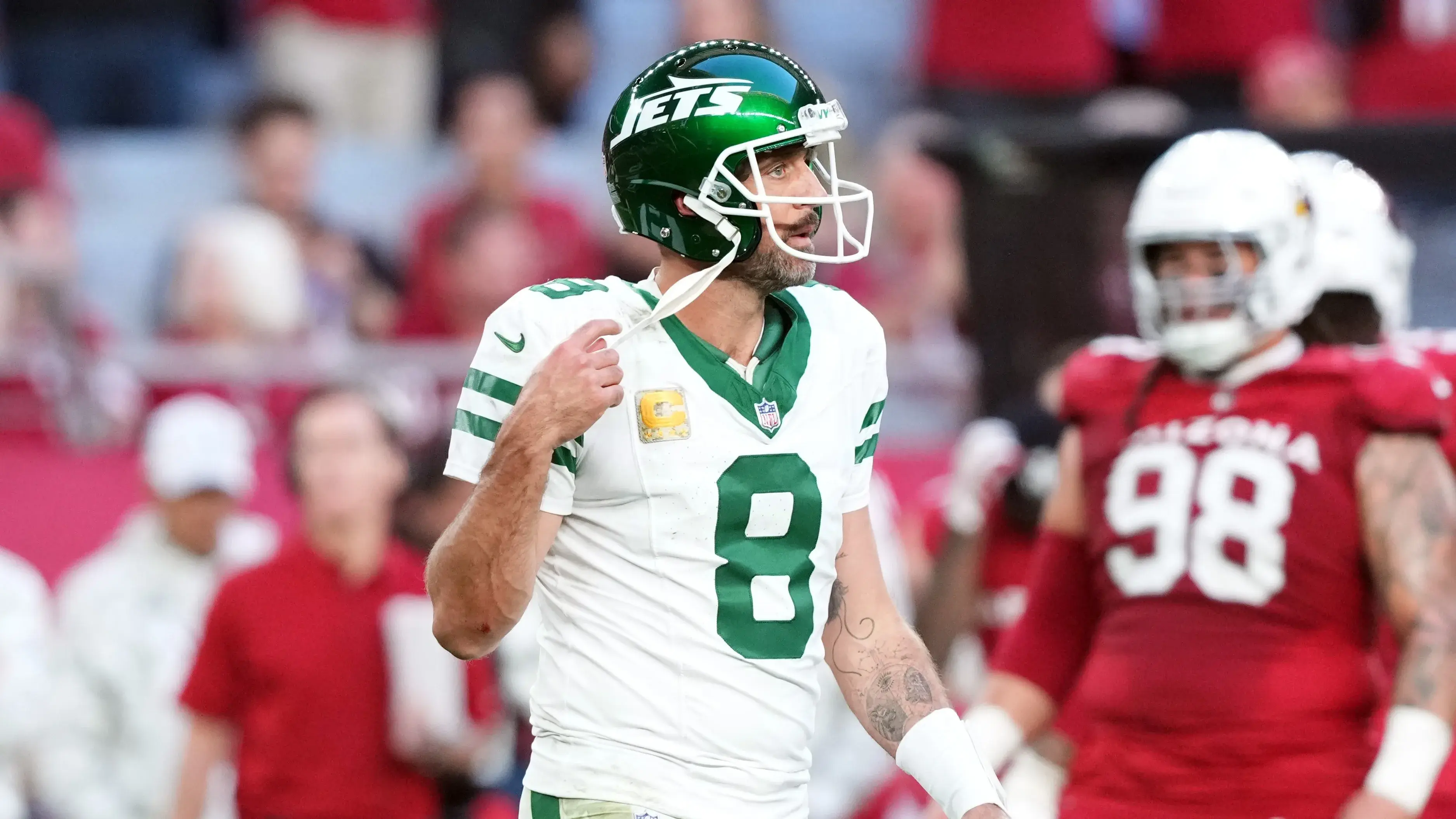 Nov 10, 2024; Glendale, Arizona, USA; New York Jets quarterback Aaron Rodgers (8) walks off the field against the Arizona Cardinals during the second half at State Farm Stadium. Mandatory Credit: Joe Camporeale-Imagn Images / © Joe Camporeale-Imagn Images