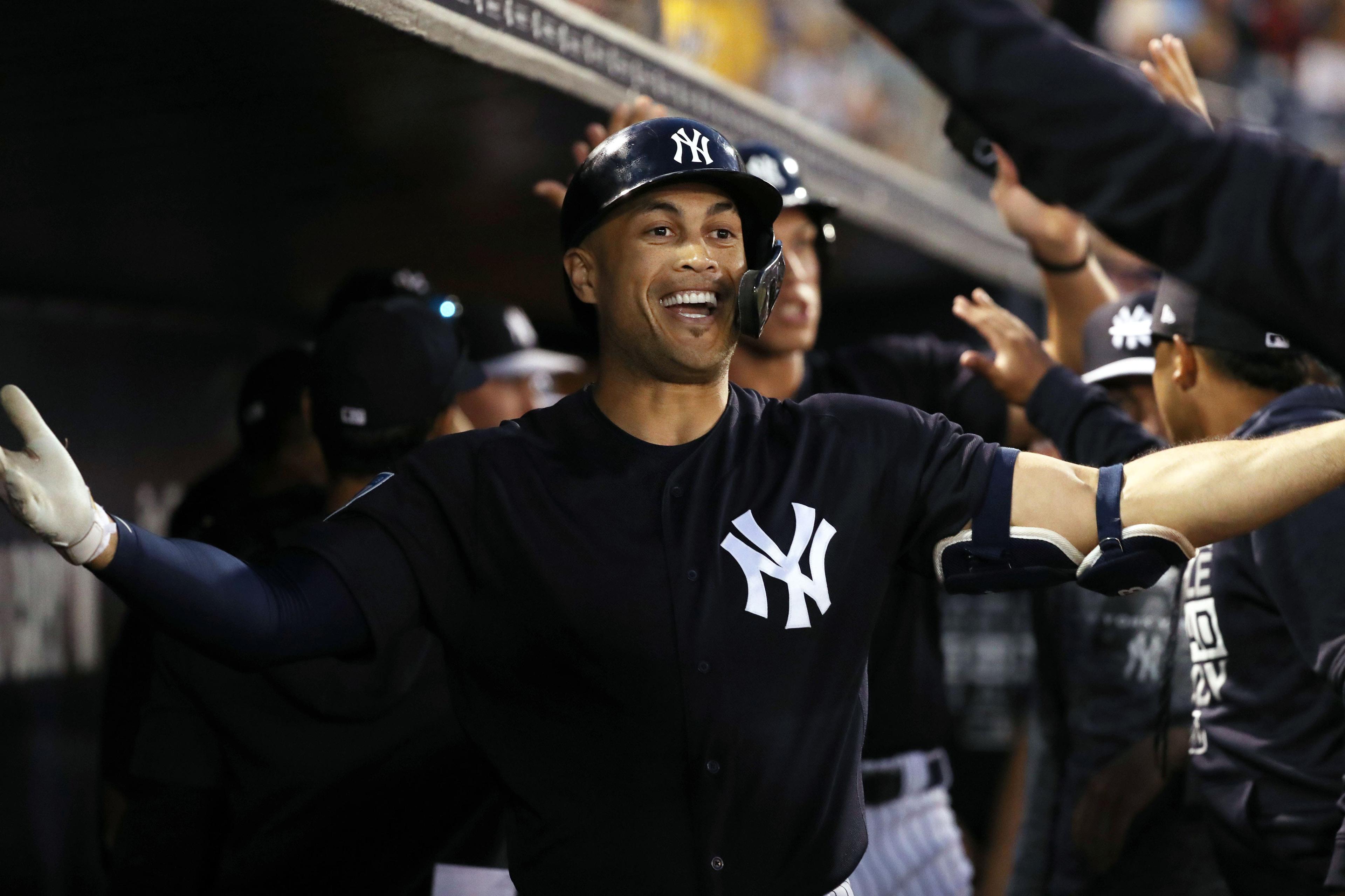 Mar 8, 2019; Tampa, FL, USA; New York Yankees left fielder Giancarlo Stanton (27) is congratulated by teammates as he hits a 2-run home run during the first inning against the Detroit Tigers at George M. Steinbrenner Field. Mandatory Credit: Kim Klement-USA TODAY Sports / Kim Klement