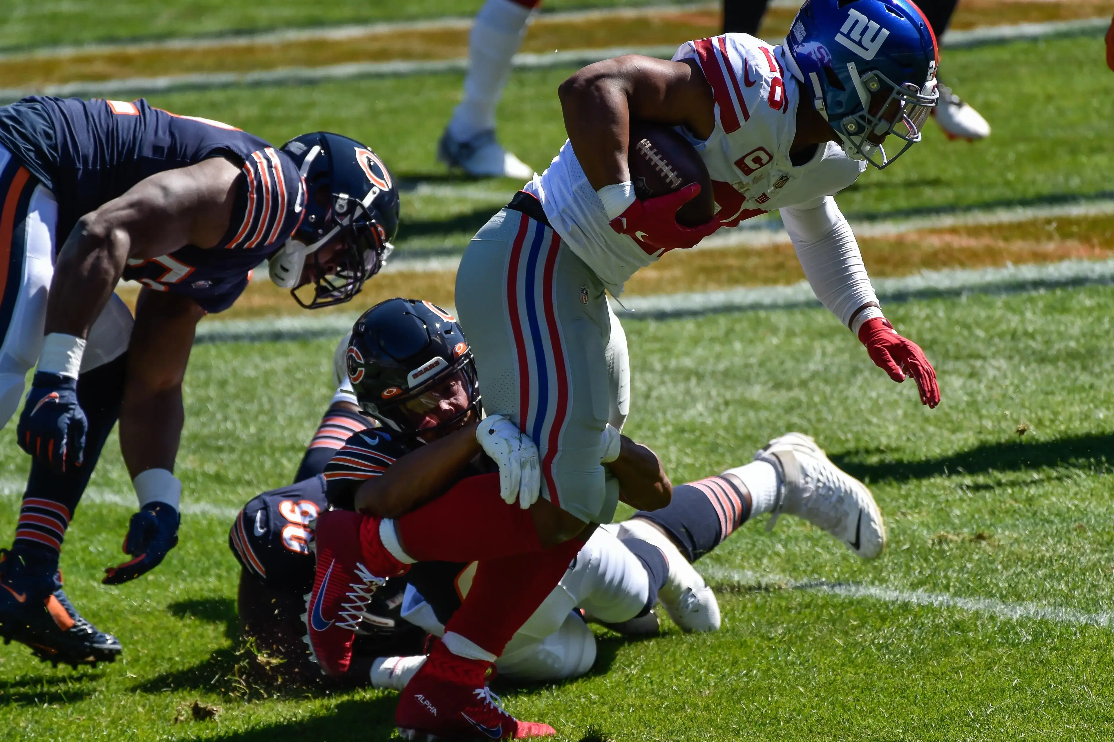 Sep 20, 2020; Chicago, Illinois, USA; New York Giants running back Saquon Barkley (26) runs the ball against the Chicago Bears during the second quarter at Soldier Field. Barkley would be injured on the play and removed from the game. / Jeffrey Becker-USA TODAY Sports