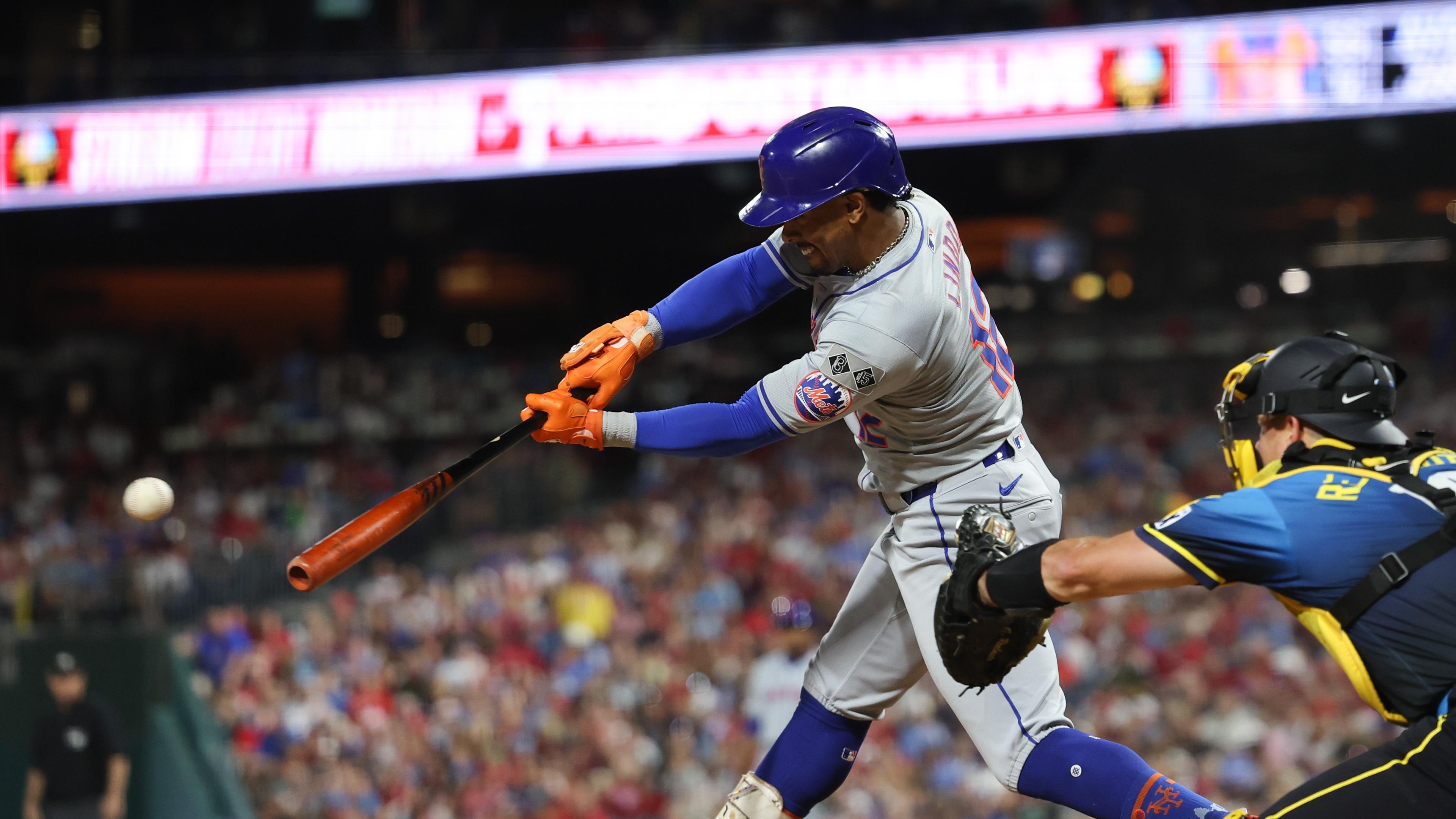 Sep 13, 2024; Philadelphia, Pennsylvania, USA; New York Mets shortstop Francisco Lindor (12) hits a single during the fifth inning against the Philadelphia Phillies at Citizens Bank Park. Mandatory Credit: Bill Streicher-Imagn Images