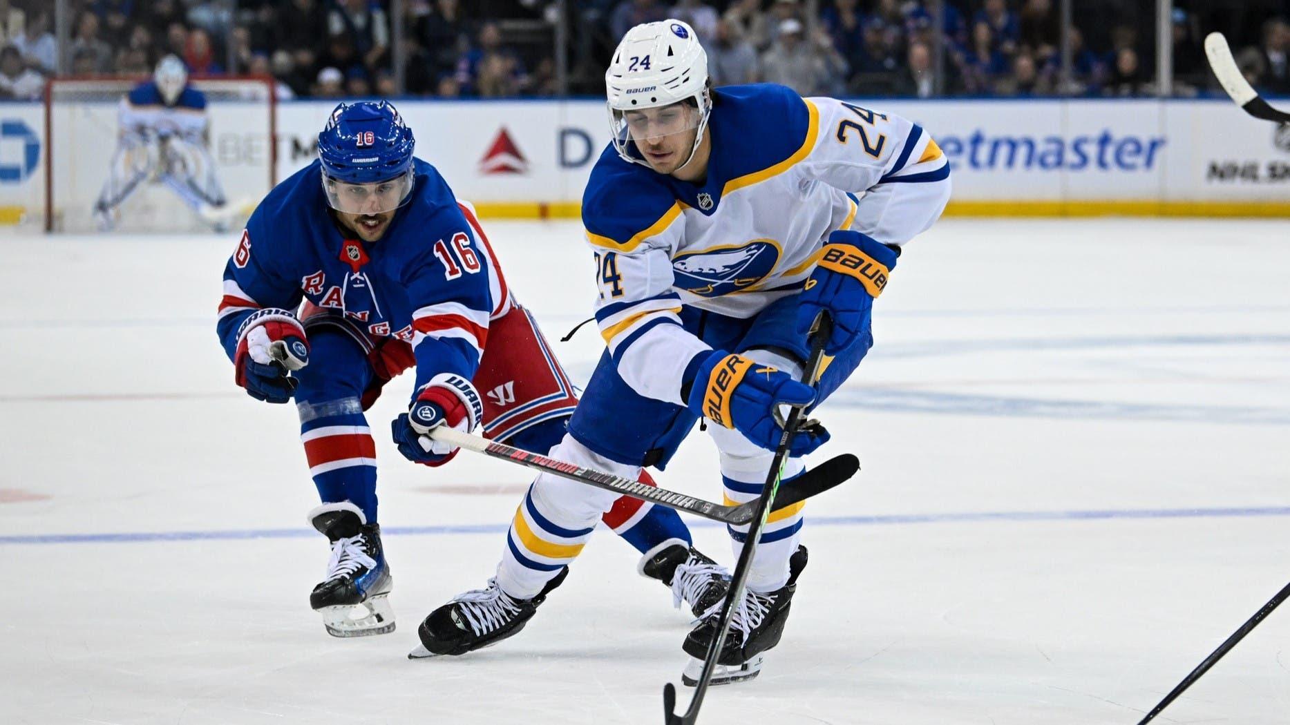 Nov 7, 2024; New York, New York, USA; Buffalo Sabres center Dylan Cozens (24) skates with the puck chased by New York Rangers center Vincent Trocheck (16) during the first period at Madison Square Garden. / Dennis Schneidler-Imagn Images