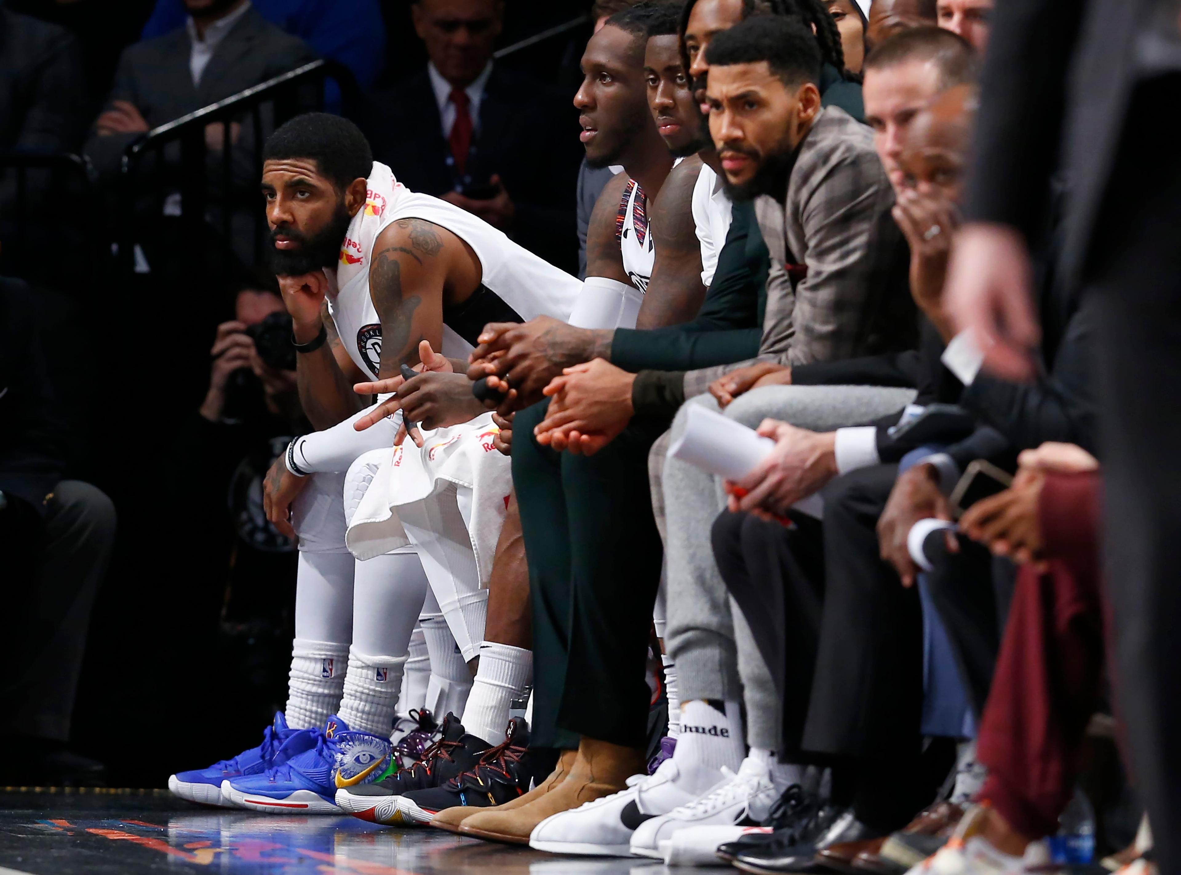 Jan 18, 2020; Brooklyn, New York, USA; Brooklyn Nets guard Kyrie Irving watches play against the Milwaukee Bucks from the bench during the second half at Barclays Center. Mandatory Credit: Noah K. Murray-USA TODAY Sports / Noah K. Murray