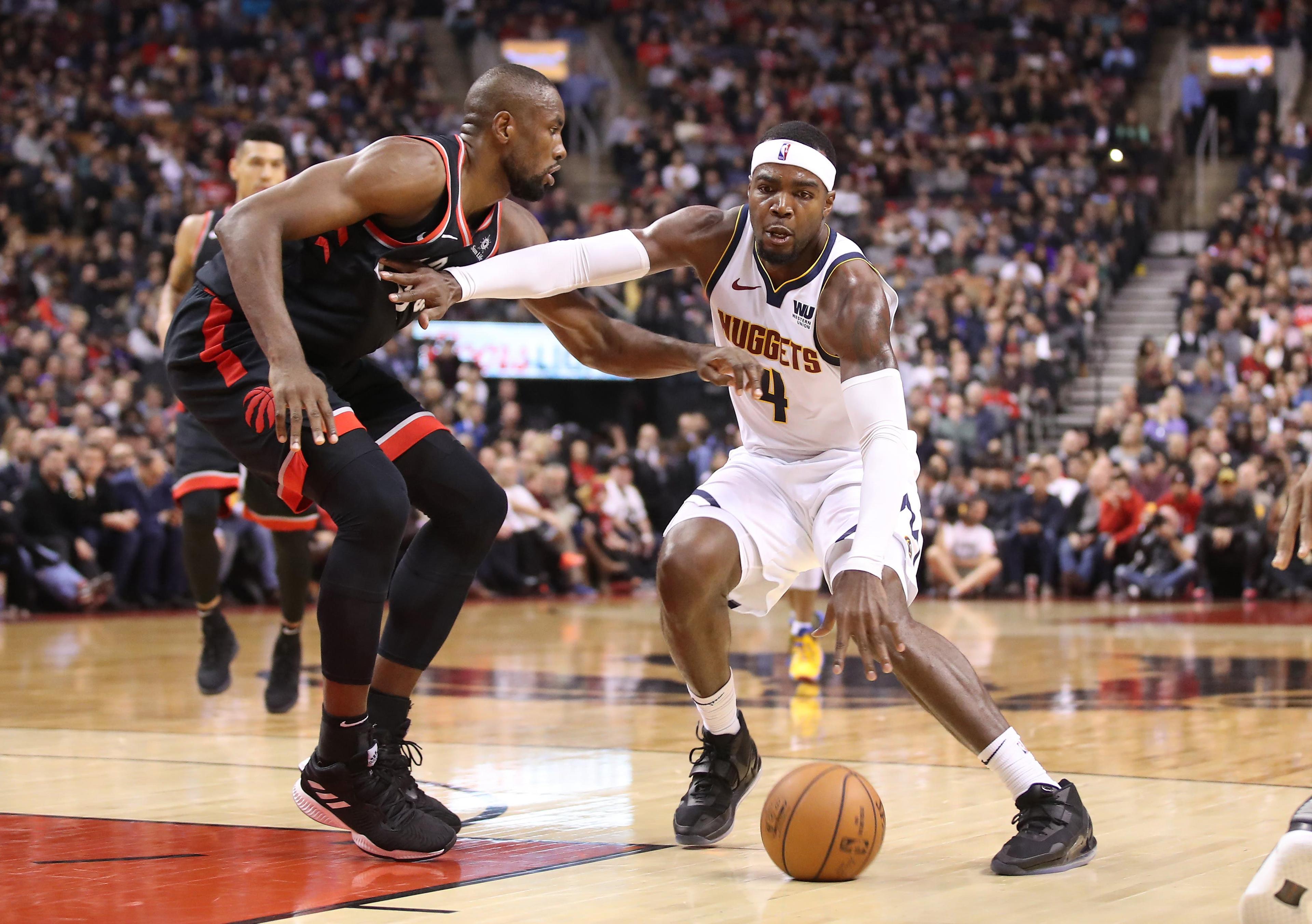 Dec 3, 2018; Toronto, Ontario, CAN; Denver Nuggets forward Paul Millsap (4) dribbles against Toronto Raptors forward Serge Ibaka (9) in the second quarter at Scotiabank Arena. / © Tom Szczerbowski-USA TODAY Sports