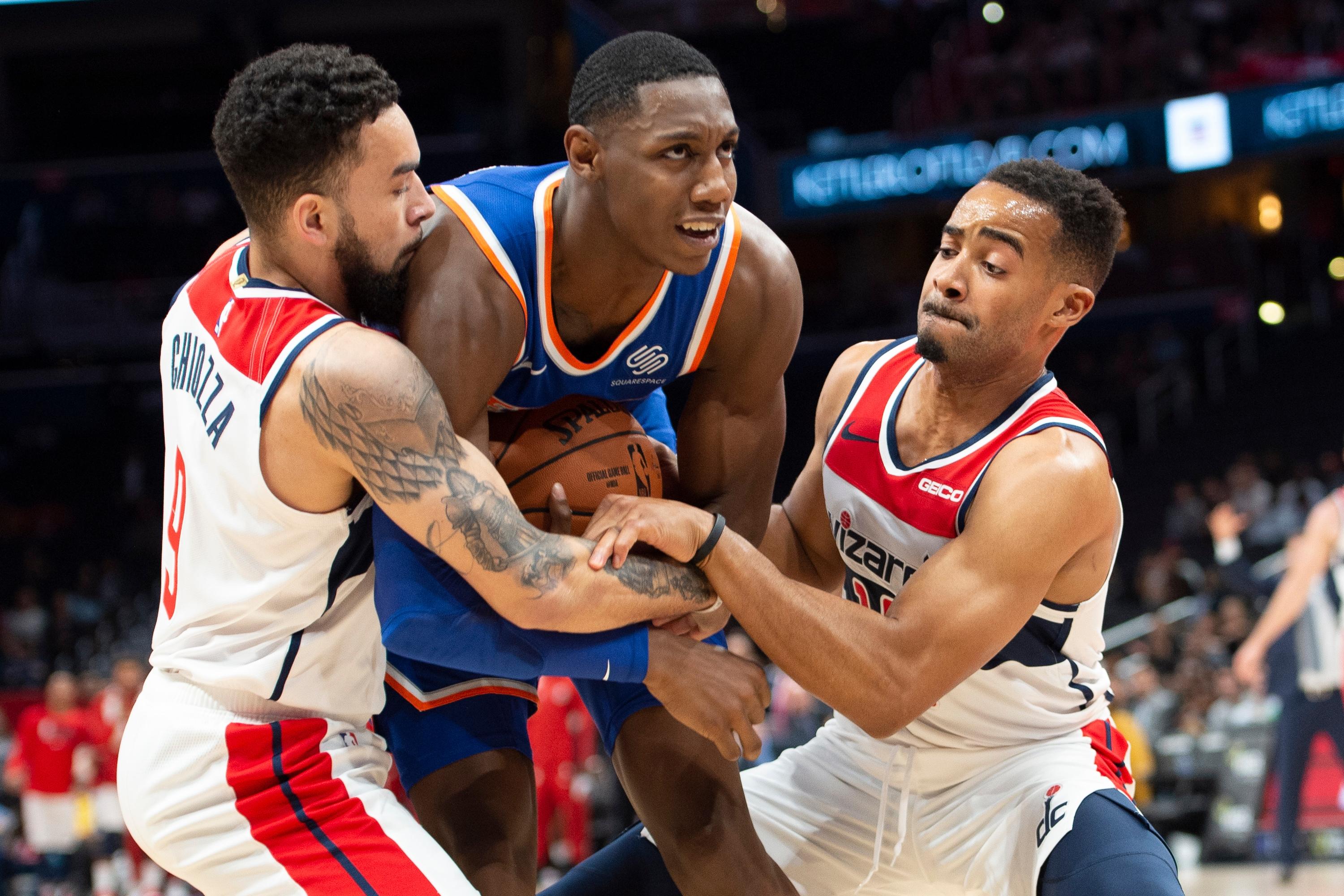 Oct 7, 2019; Washington, DC, USA; Washington Wizards forward Chris Chiozza (9) and guard Phil Booth (15) foul New York Knicks forward RJ Barrett (9) during the second half at Capital One Arena. Mandatory Credit: Tommy Gilligan-USA TODAY Sports