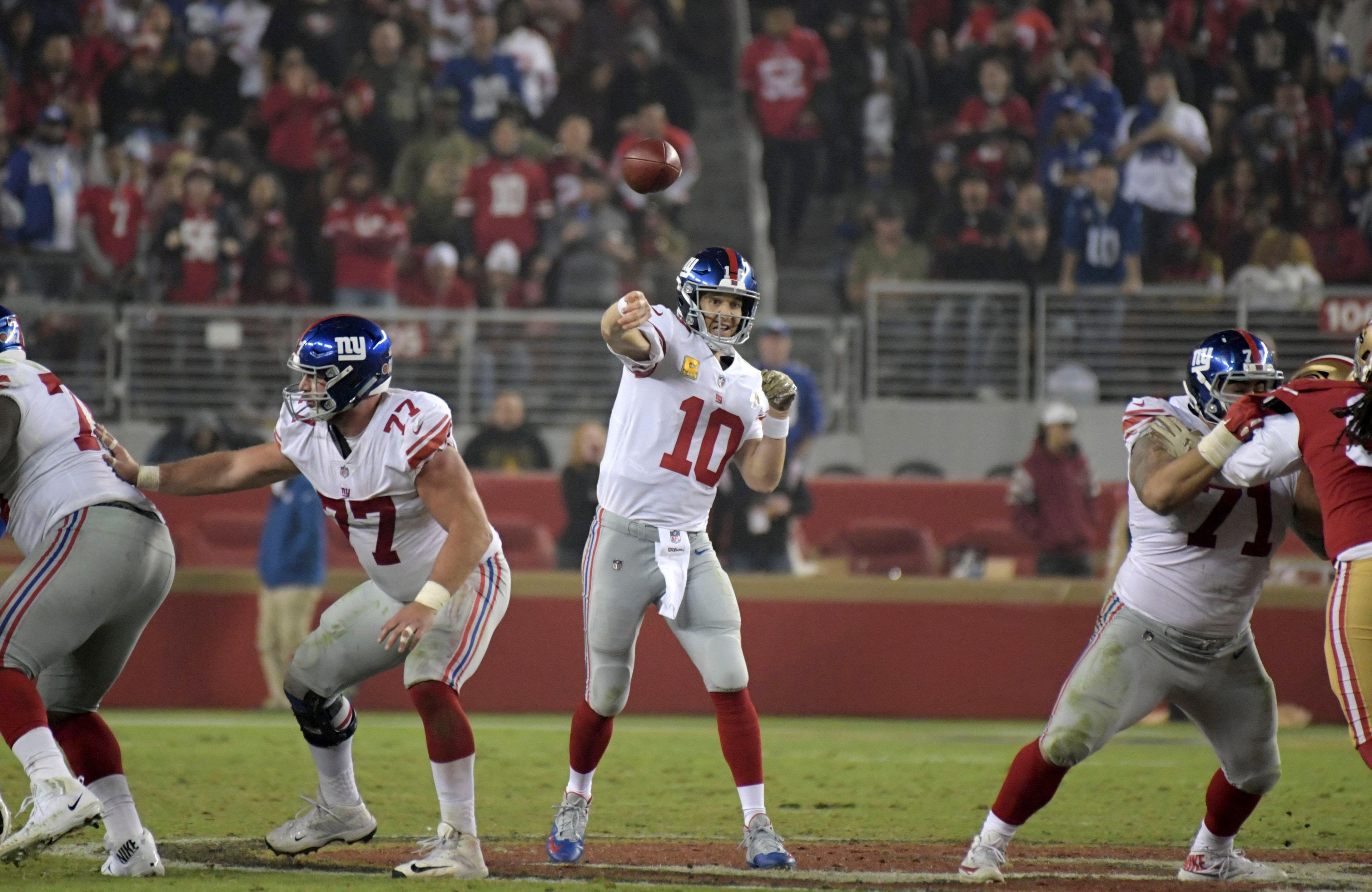 New York Giants quarterback Eli Manning throws a pass under pressure from San Francisco 49ers defensive tackle DeForest Buckner at Levi's Stadium. / Kirby Lee/USA TODAY Sports