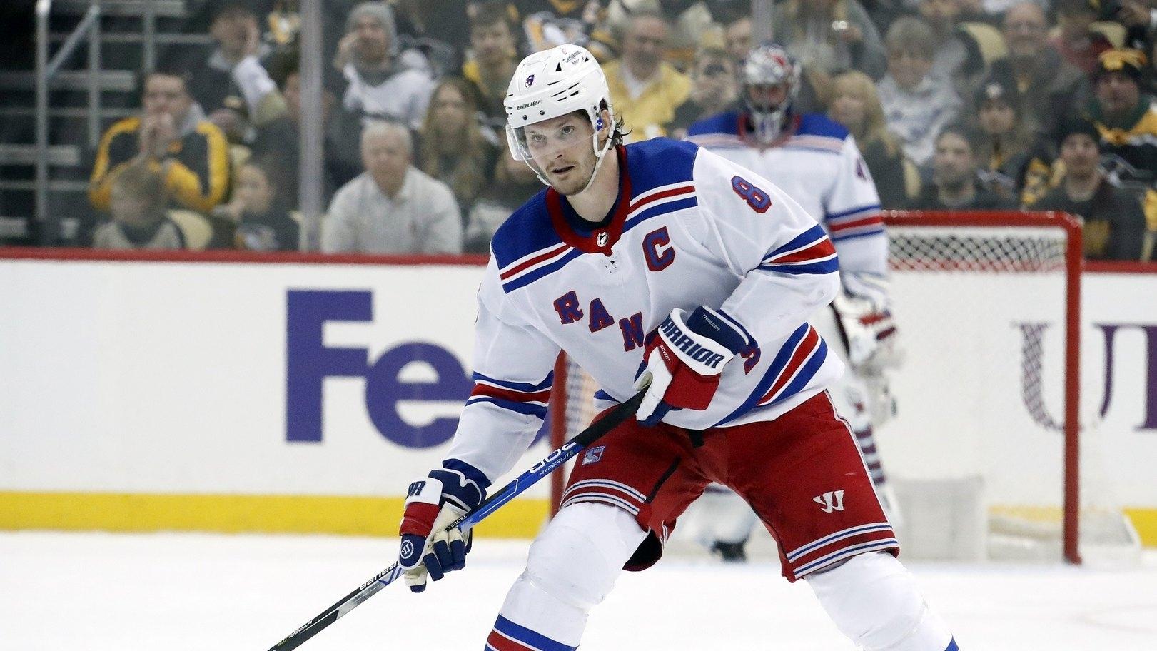 New York Rangers defenseman Jacob Trouba (8) skates up ice with the puck against the Pittsburgh Penguins.