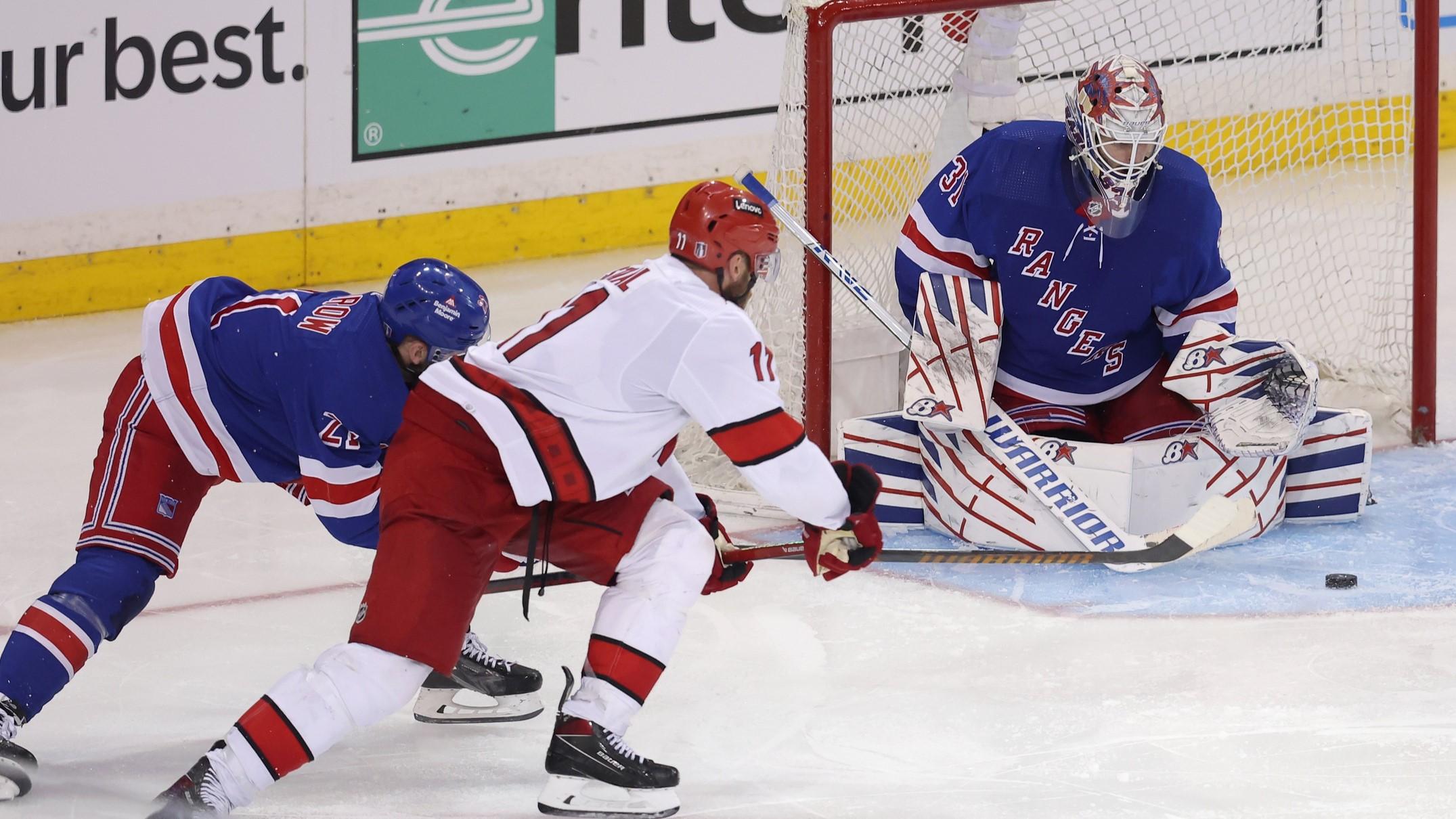 May 7, 2024; New York, New York, USA; New York Rangers goaltender Igor Shesterkin (31) makes a save against Carolina Hurricanes center Jordan Staal (11) in front of Rangers center Barclay Goodrow (21) during the second overtime of game two of the second round of the 2024 Stanley Cup Playoffs at Madison Square Garden. / Brad Penner-USA TODAY Sports