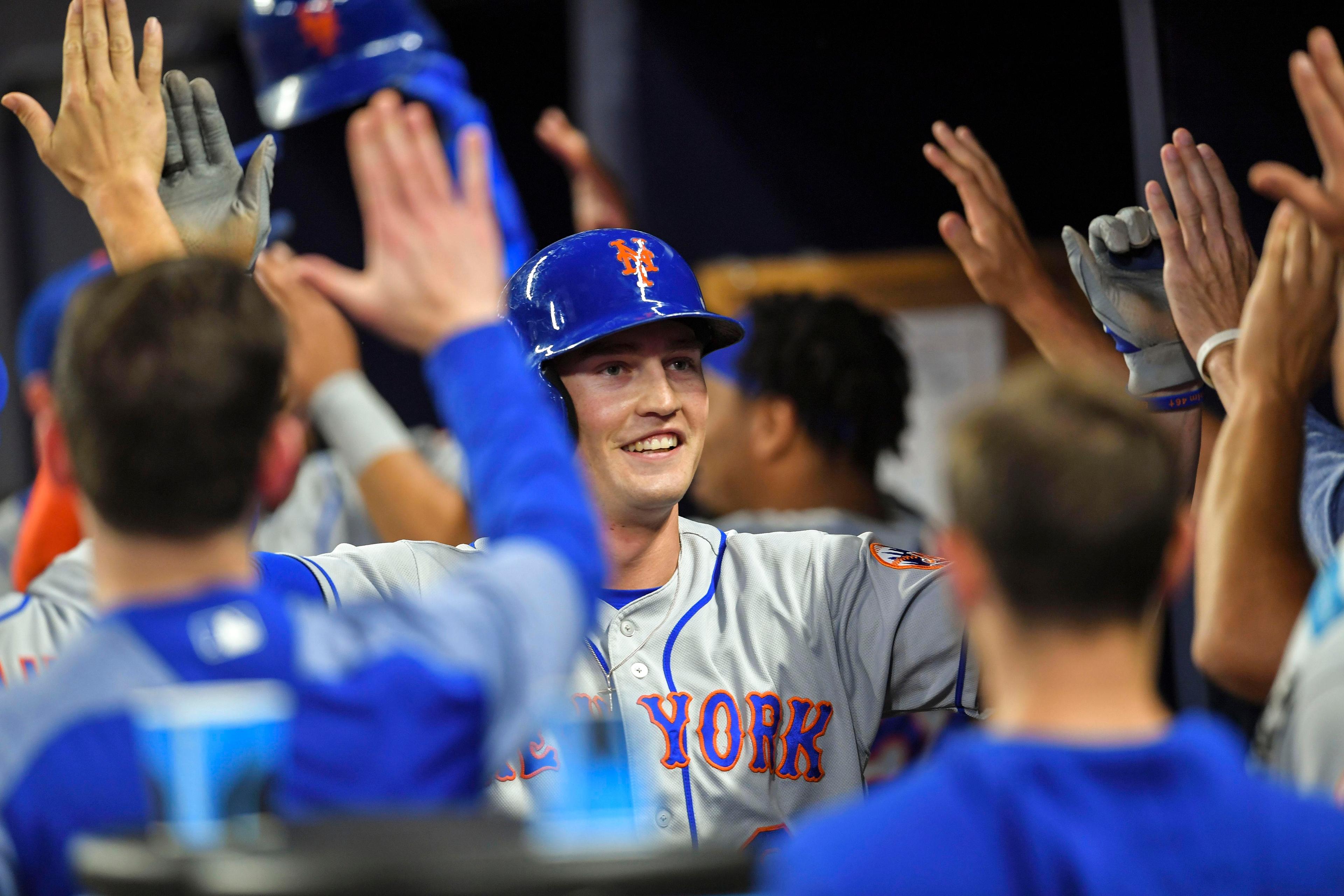 Apr 12, 2019; Atlanta, GA, USA; New York Mets Brandon Nimmo (9) gets high fives after scoring against the Atlanta Braves during the fourth inning at SunTrust Park. Mandatory Credit: Dale Zanine-USA TODAY Sports