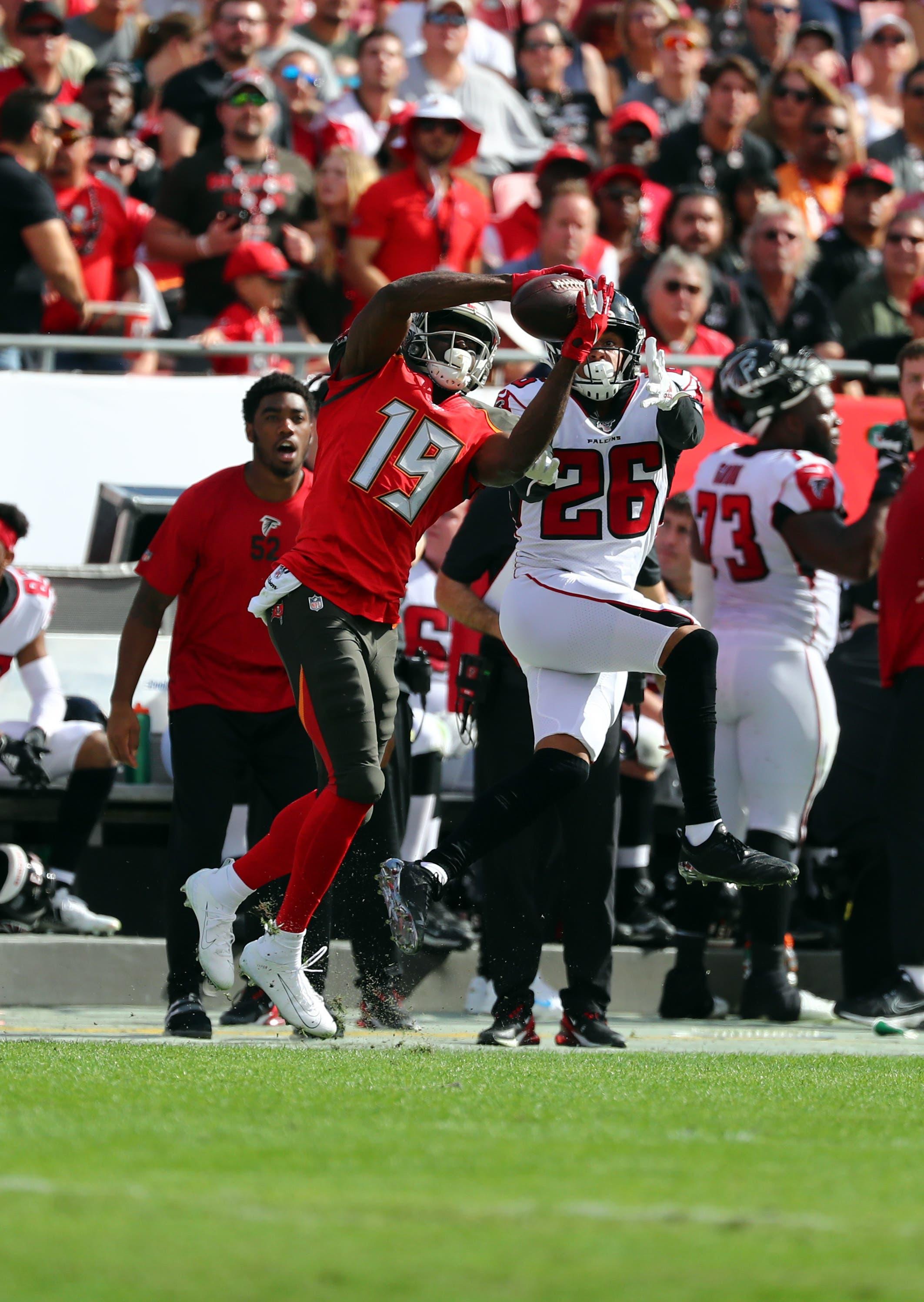 Dec 29, 2019; Tampa, Florida, USA; Tampa Bay Buccaneers wide receiver Breshad Perriman (19) catches the ball over Atlanta Falcons cornerback Isaiah Oliver (26) during the first quarter at Raymond James Stadium. Mandatory Credit: Kim Klement-USA TODAY Sports / Kim Klement