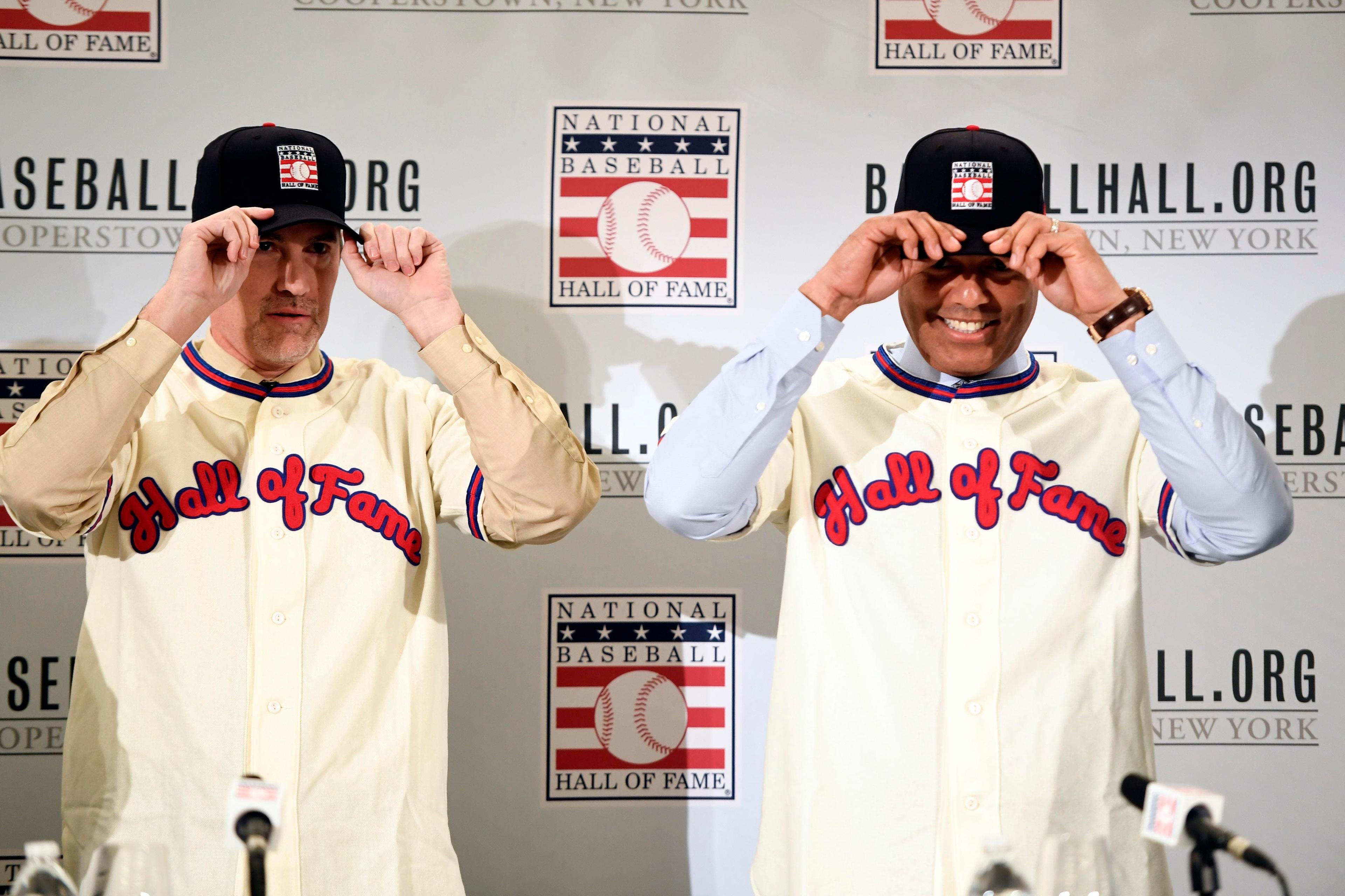 New York Yankees former pitchers Mike Mussina and Mariano Rivera put on jerseys at a press conference after being elected into the Hall of Fame. / Danielle Parhizkaran/NorthJersey.com via USA TODAY NETWORK