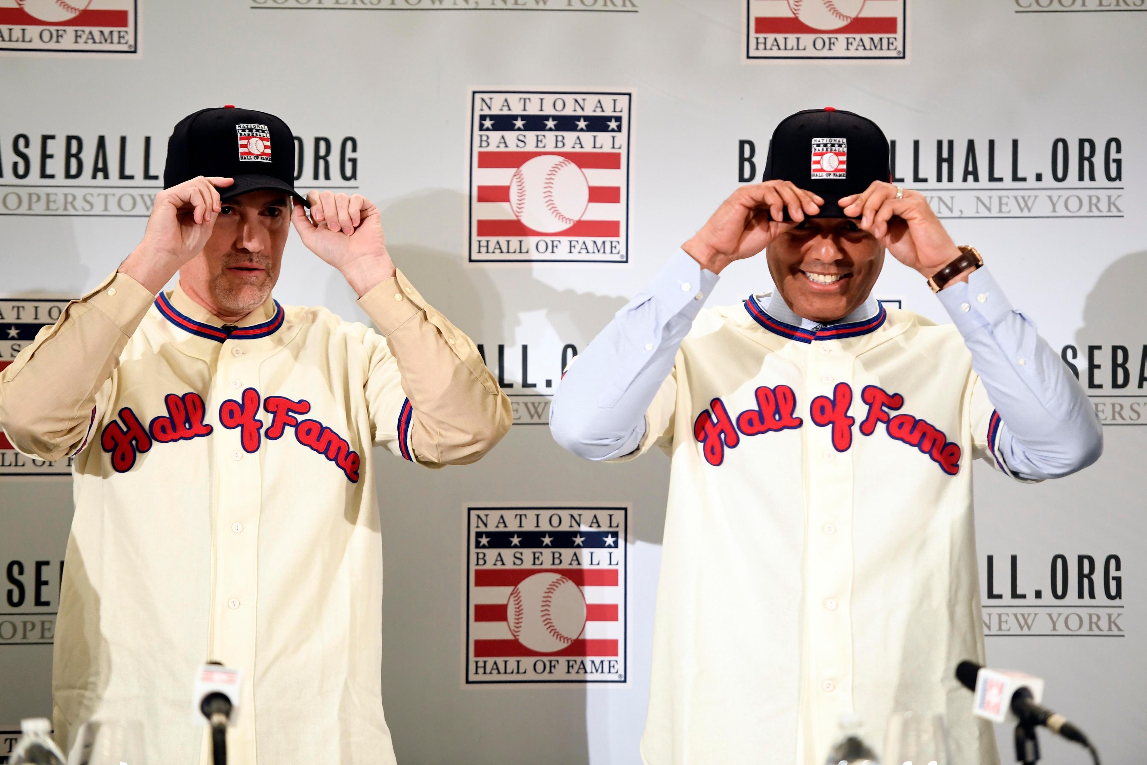 New York Yankees former pitchers Mike Mussina and Mariano Rivera put on jerseys at a press conference after being elected into the Hall of Fame.