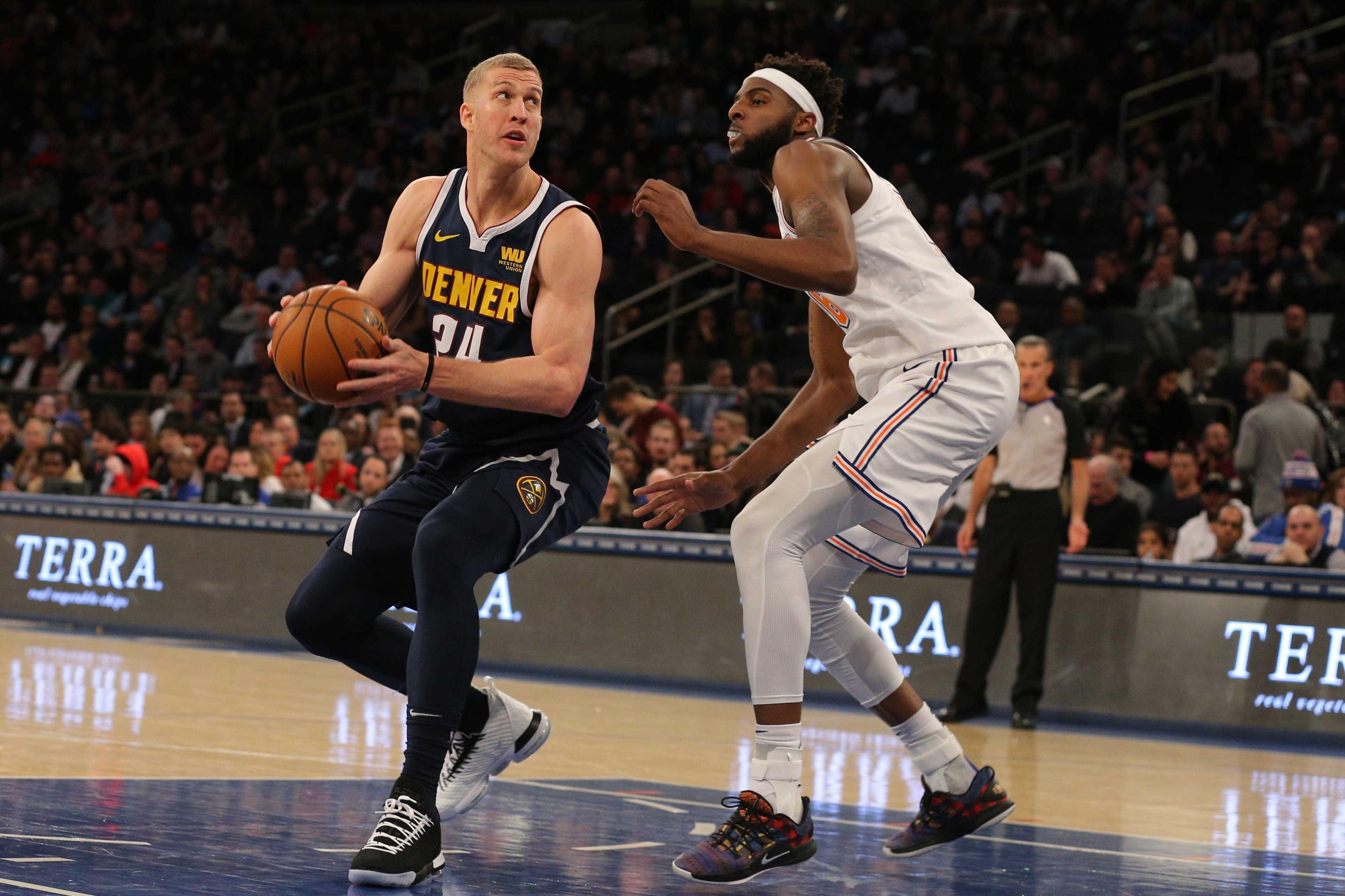 Mar 22, 2019; New York, NY, USA; Denver Nuggets power forward Mason Plumlee (24) controls the ball against New York Knicks center Mitchell Robinson (26) during the second quarter at Madison Square Garden. Mandatory Credit: Brad Penner-USA TODAY Sports / Brad Penner