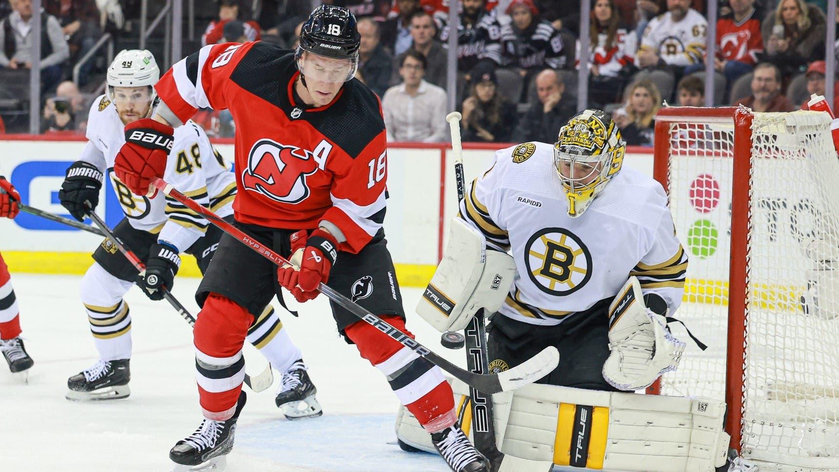 Dec 13, 2023; Newark, New Jersey, USA; Boston Bruins goaltender Jeremy Swayman (1) makes a save behind New Jersey Devils left wing Ondrej Palat (18) during the first period at Prudential Center. / Vincent Carchietta-USA TODAY Sports