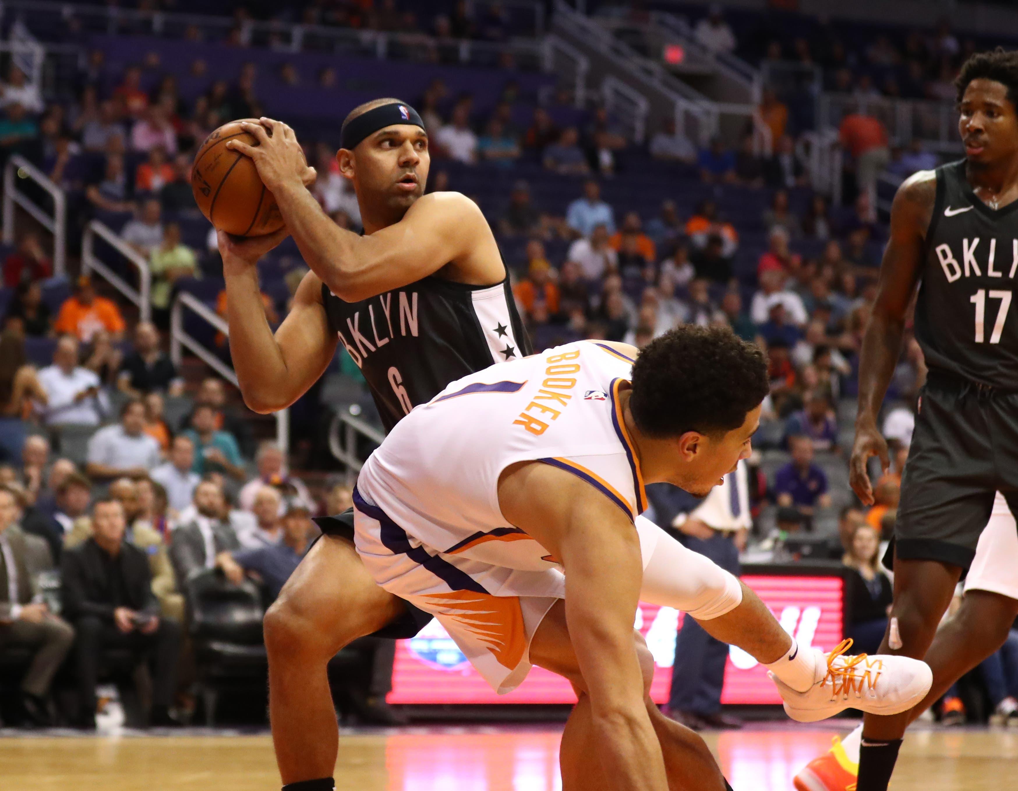 Nov 6, 2018; Phoenix, AZ, USA; Brooklyn Nets forward Jared Dudley (left) grabs a rebound against Phoenix Suns guard Devin Booker in the second half at Talking Stick Resort Arena. Mandatory Credit: Mark J. Rebilas-USA TODAY Sportsundefined