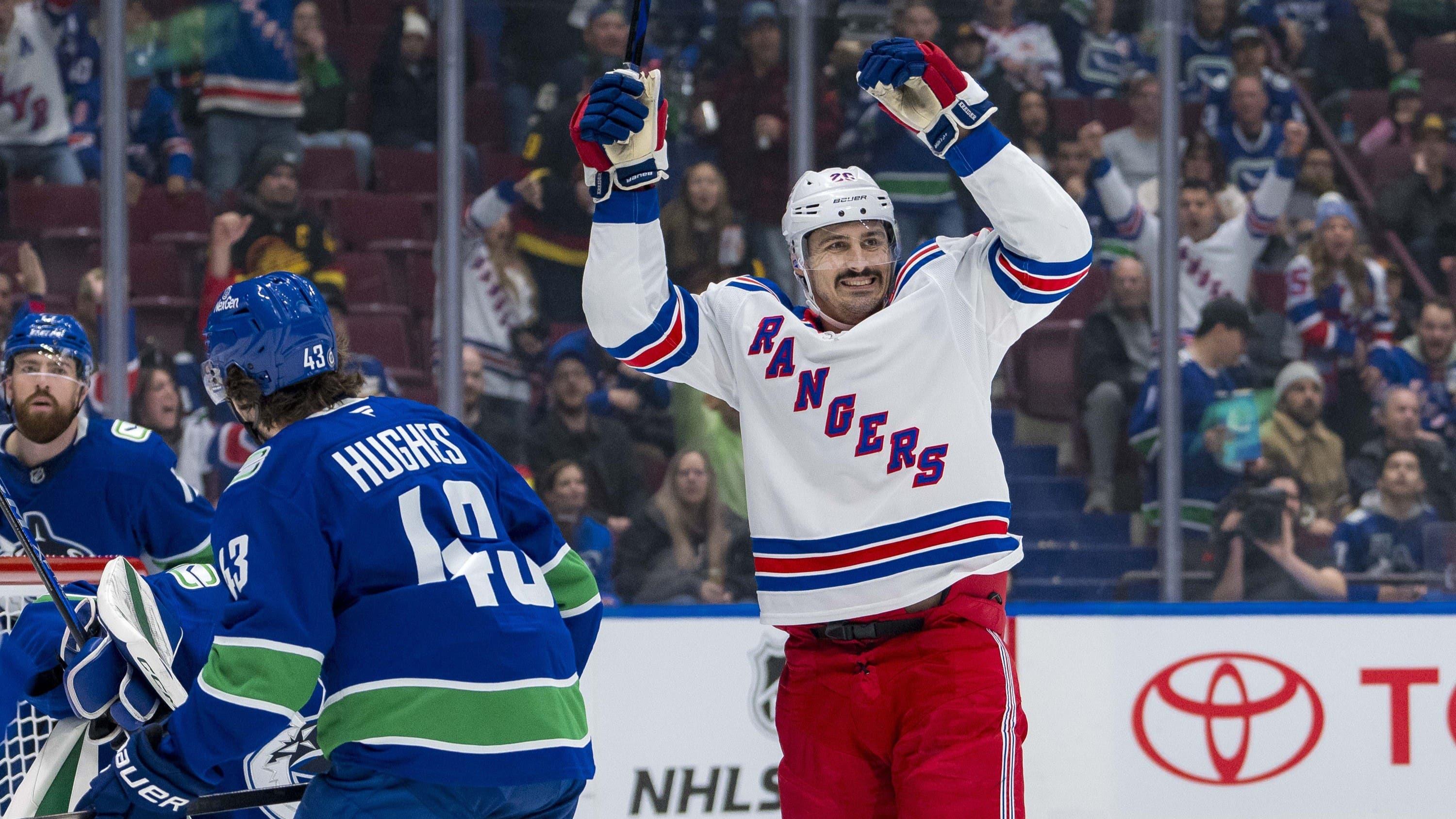 Nov 19, 2024; Vancouver, British Columbia, CAN; Vancouver Canucks defenseman Quinn Hughes (43) watches as New York Rangers forward Chris Kreider (20) celebrates a goal scored by forward Mika Zibanejad (93) during the first period at Rogers Arena. / Bob Frid-Imagn Images