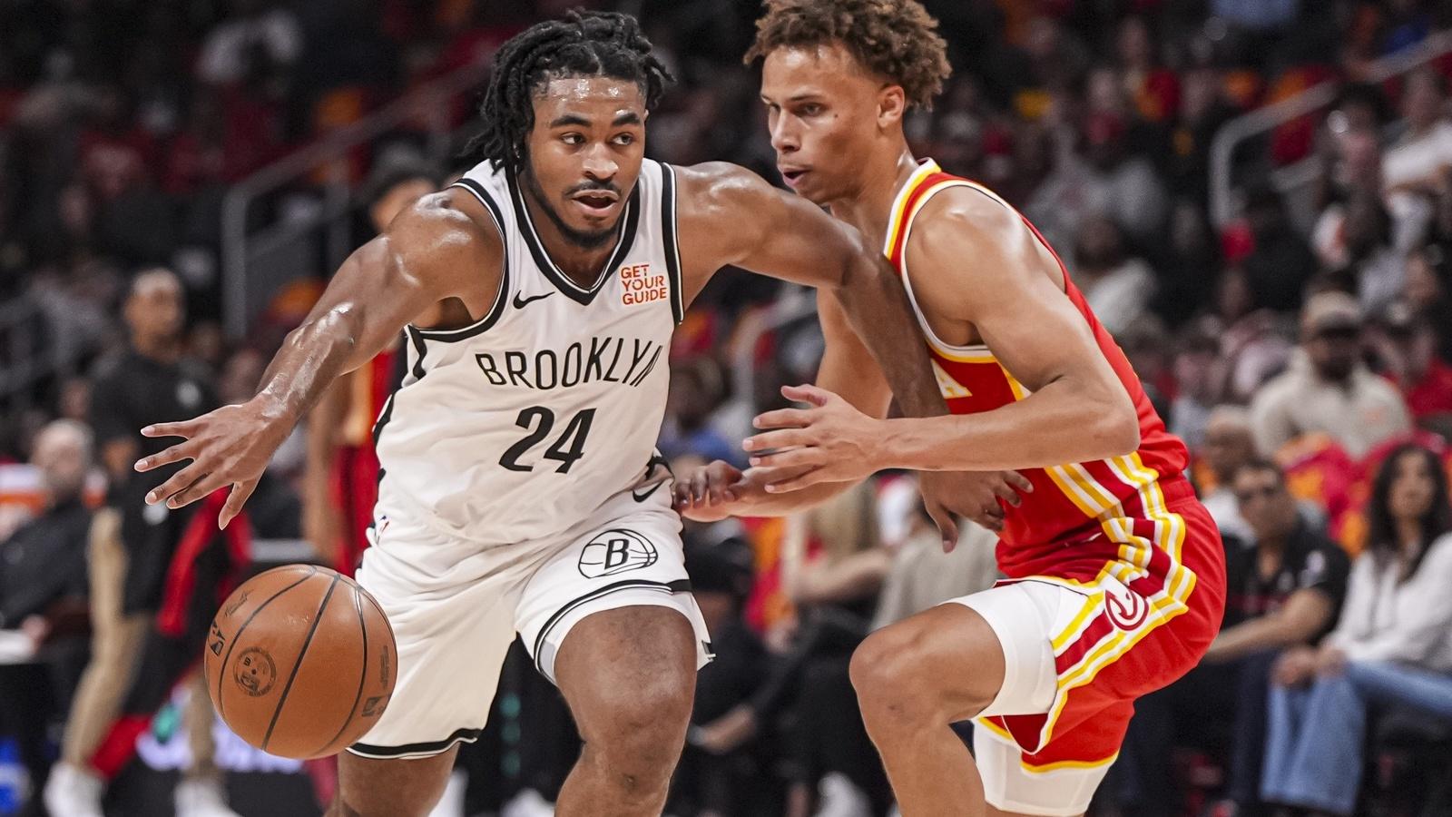 Brooklyn Nets guard Cam Thomas (24) tries to dribble against Atlanta Hawks guard Dyson Daniels (5) during the first half at State Farm Arena.