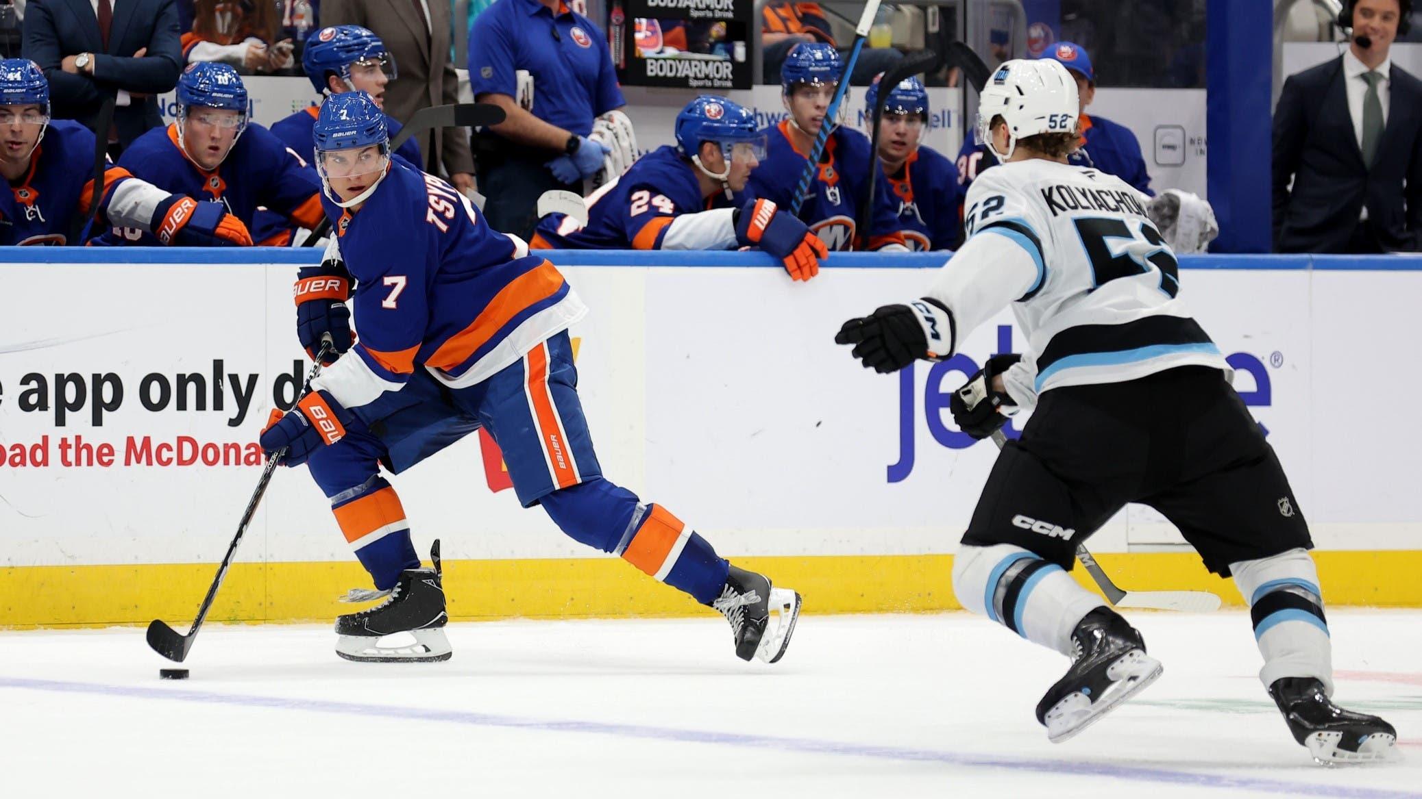 Oct 10, 2024; Elmont, New York, USA; New York Islanders right wing Maxim Tsyplakov (7) controls the puck against Utah Hockey Club defenseman Vladislav Kolyachonok (52) during the second period at UBS Arena. / Brad Penner-Imagn Images