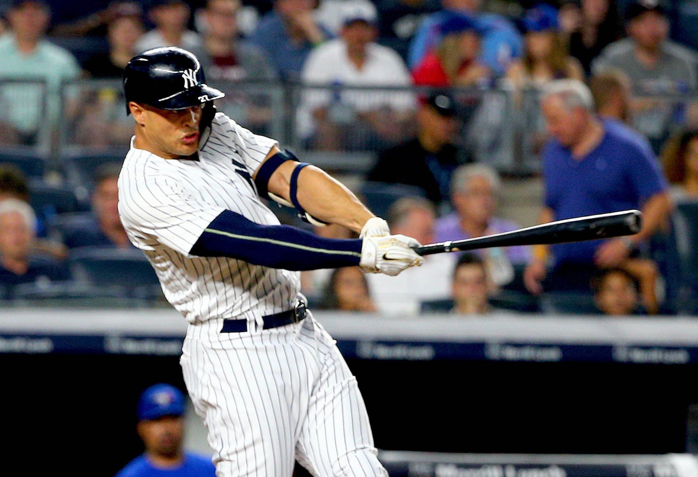 New York Yankees designated hitter Giancarlo Stanton singles against the Toronto Blue Jays during the third inning at Yankee Stadium. / Andy Marlin/USA TODAY Sports