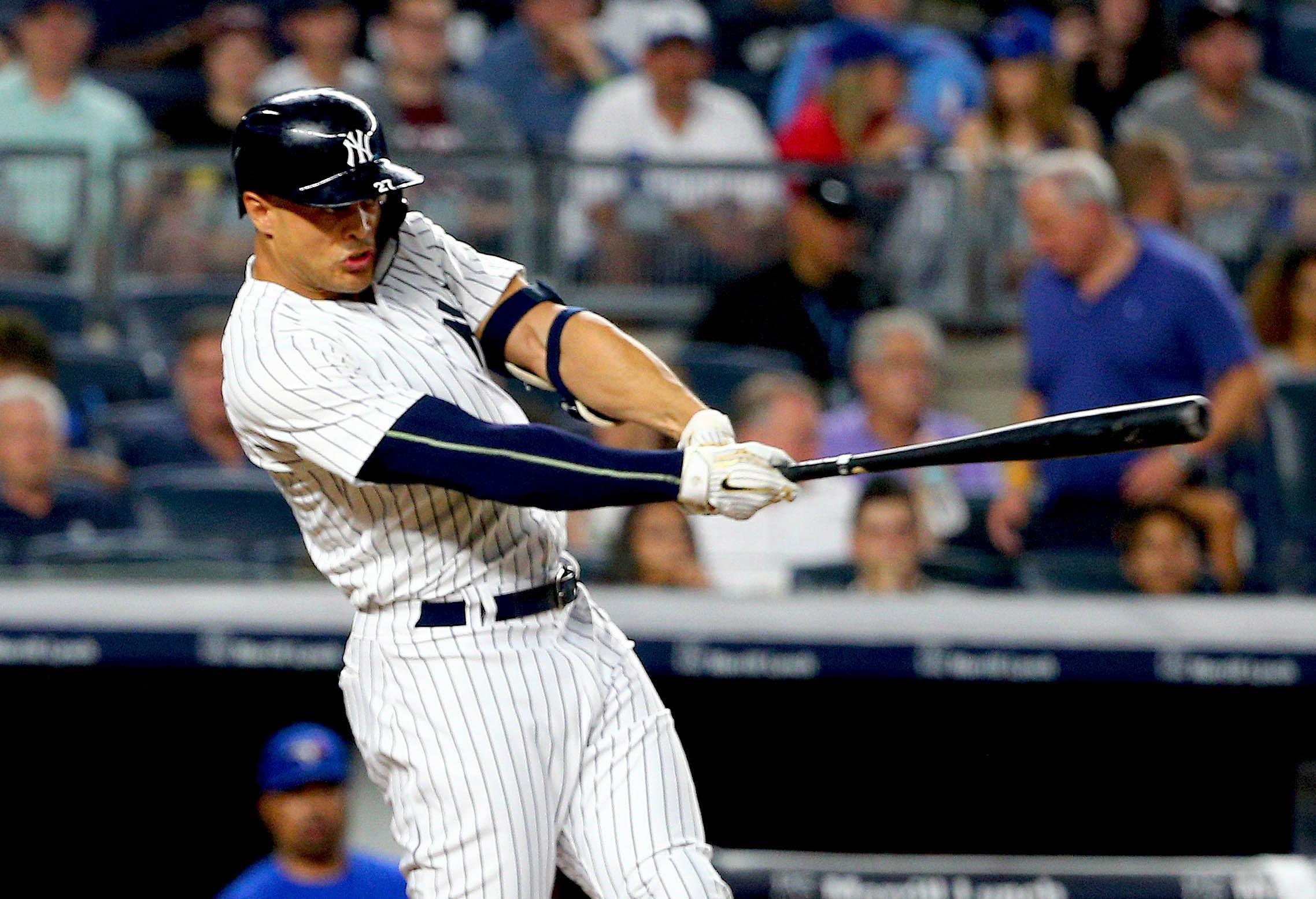 New York Yankees designated hitter Giancarlo Stanton singles against the Toronto Blue Jays during the third inning at Yankee Stadium.