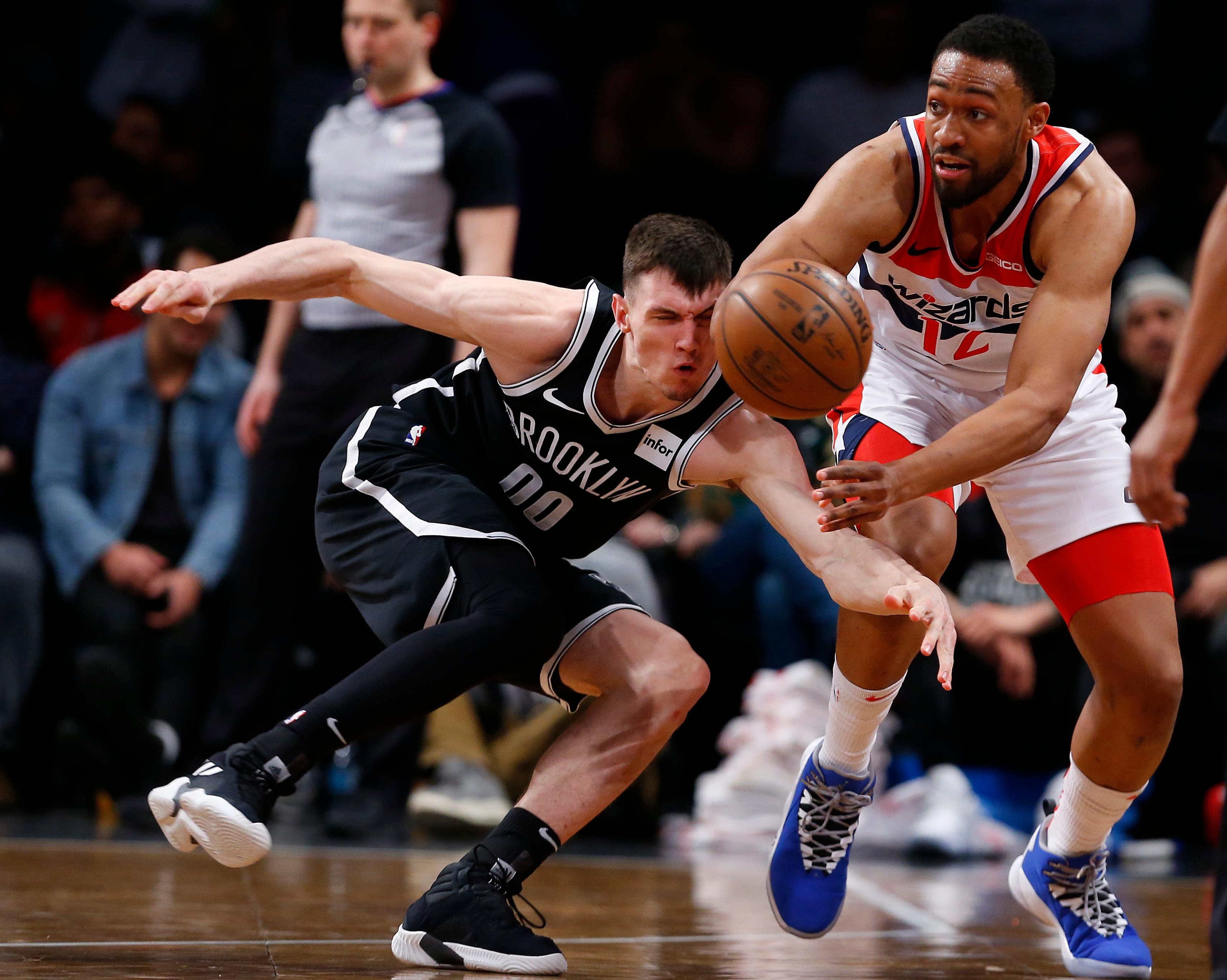 Feb 27, 2019; Brooklyn, NY, USA; Brooklyn Nets forward Rodions Kurucs (00) pressures Washington Wizards forward Jabari Parker (12) during the second half at Barclays Center. Mandatory Credit: Noah K. Murray-USA TODAY Sports