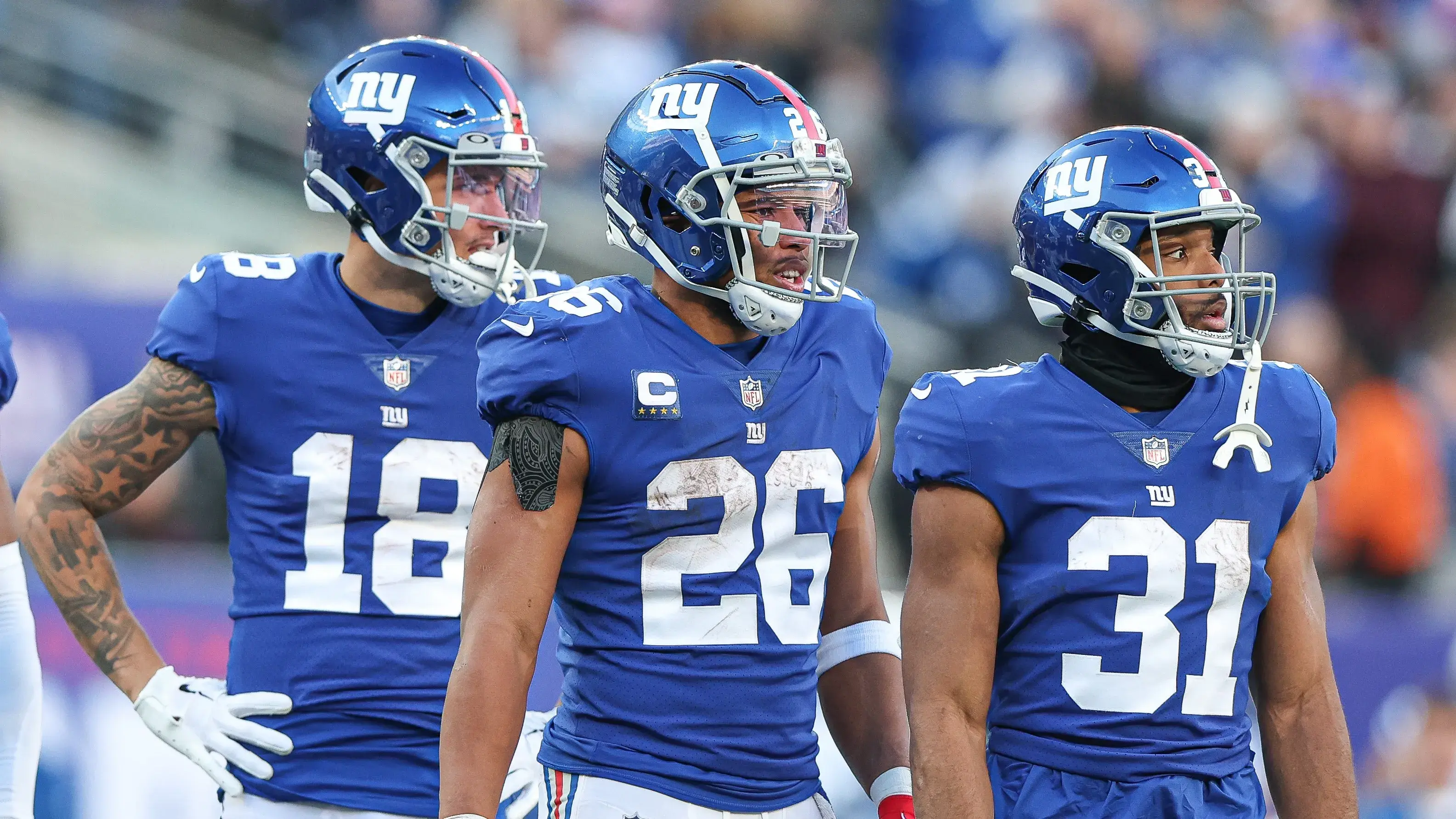 Jan 1, 2023; East Rutherford, New Jersey, USA; New York Giants running back Saquon Barkley (26) looks back with running back Matt Breida (31) and wide receiver Isaiah Hodgins (18) during the second half against the Indianapolis Colts at MetLife Stadium. Mandatory Credit: Vincent Carchietta-USA TODAY Sports / © Vincent Carchietta-USA TODAY Sports