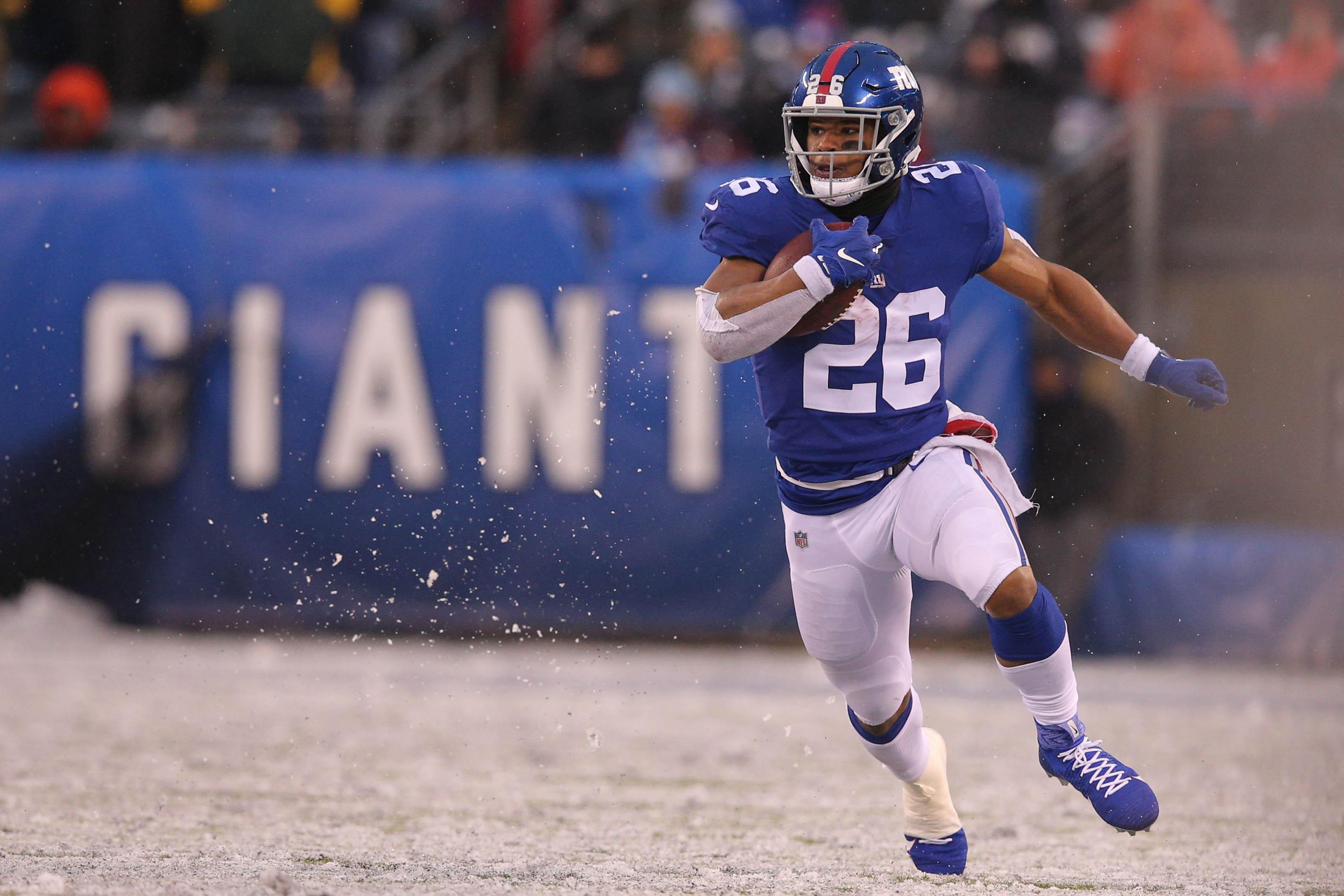 Dec 1, 2019; East Rutherford, NJ, USA; New York Giants running back Saquon Barkley (26) runs the ball against the Green Bay Packers during the fourth quarter at MetLife Stadium. Mandatory Credit: Brad Penner-USA TODAY Sports