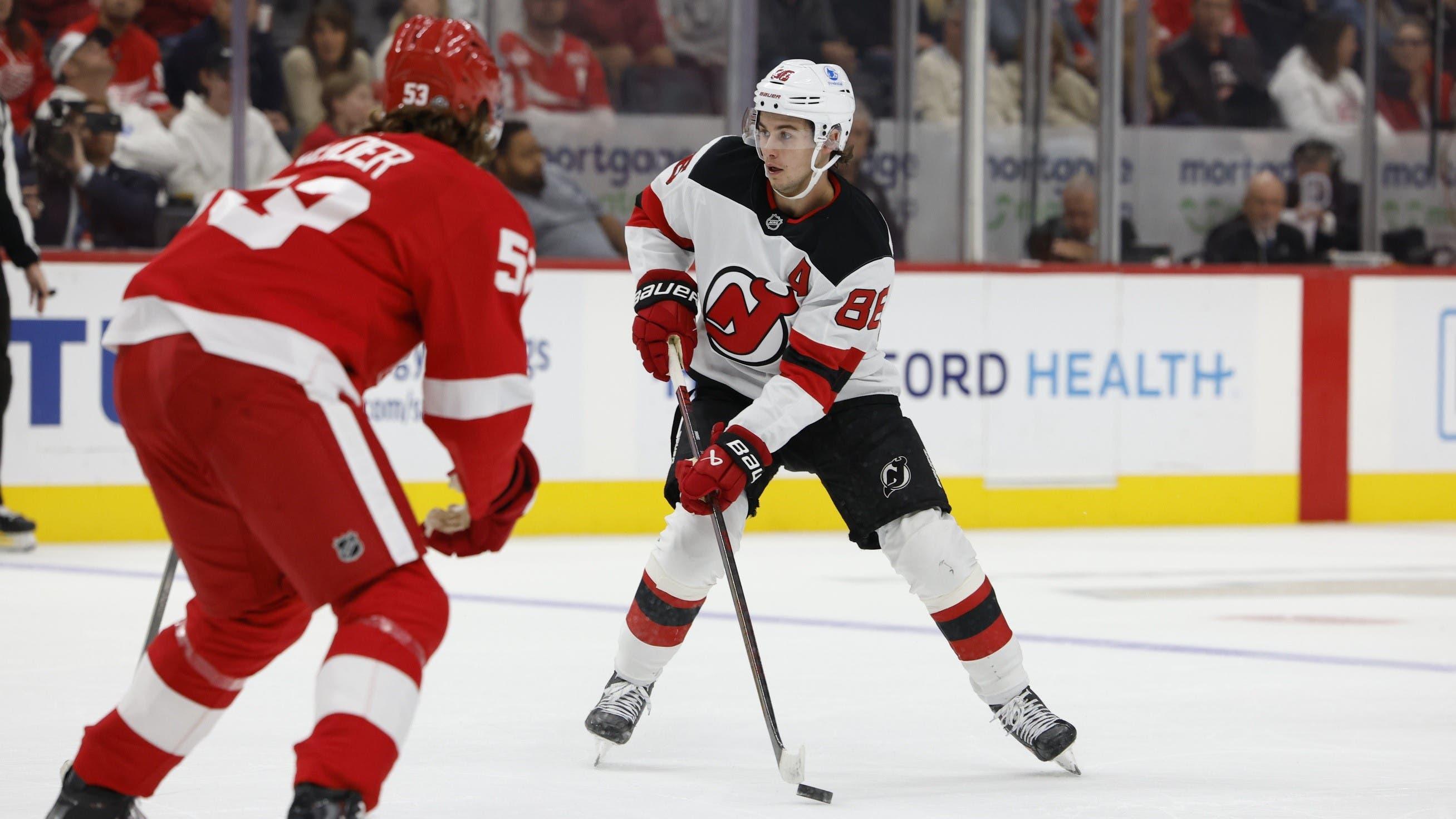 Oct 24, 2024; Detroit, Michigan, USA; New Jersey Devils center Jack Hughes (86) skates with the puck defended by Detroit Red Wings defenseman Moritz Seider (53) in the first period at Little Caesars Arena. / Rick Osentoski-Imagn Images