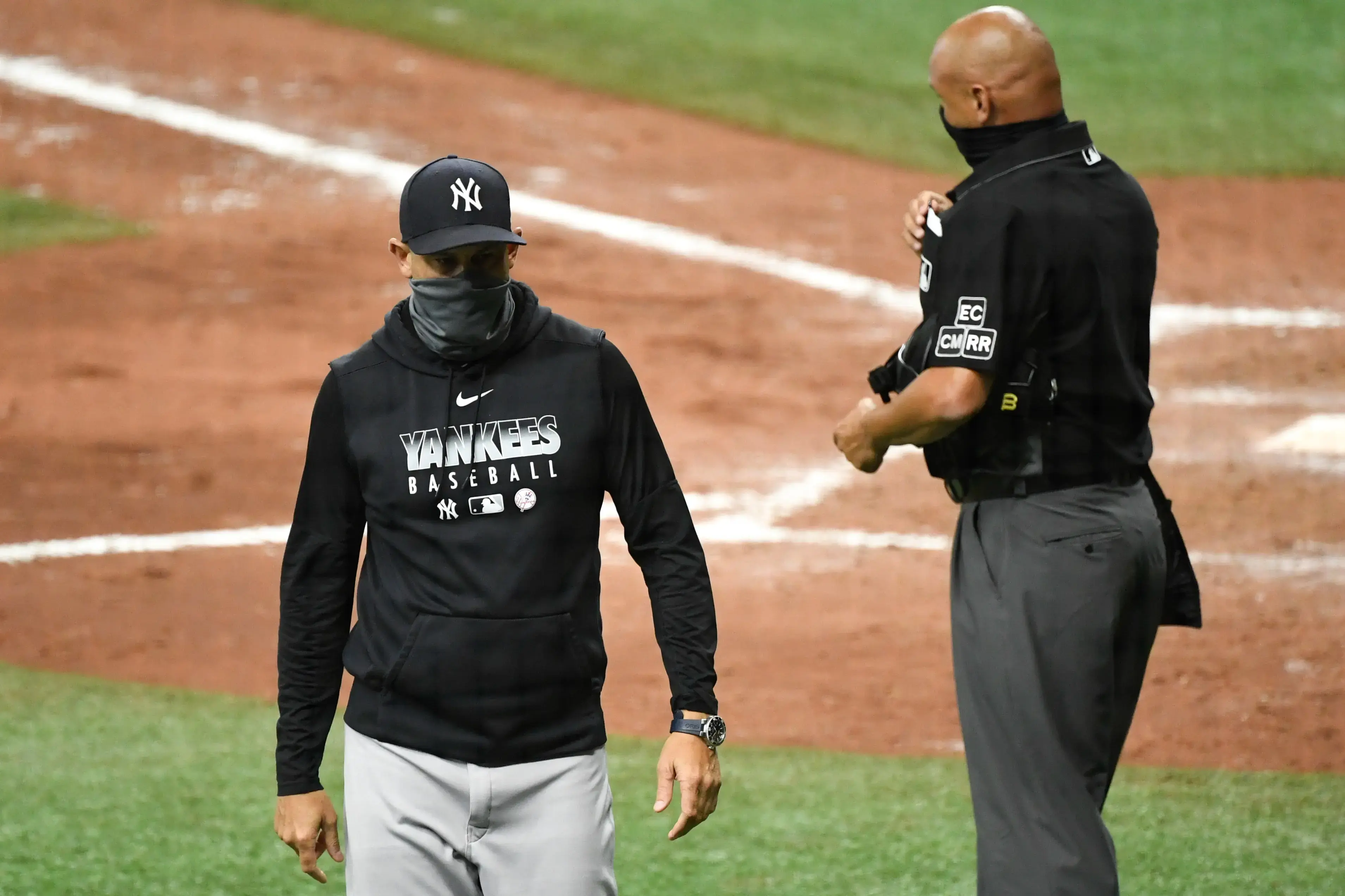 Aug 8, 2020; St. Petersburg, Florida, USA; New York Yankees manager Aaron Boone (17) walks off the field after being ejected from the game by umpire Vic Carapazza (19) during the fifth inning against the Tampa Bay Rays at Tropicana Field. Mandatory Credit: Douglas DeFelice-USA TODAY Sports / USA TODAY